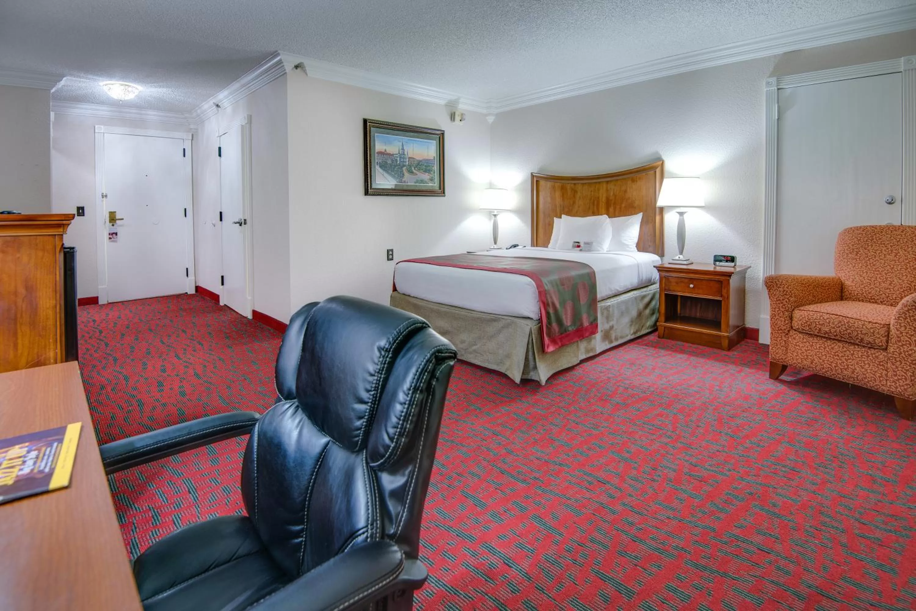Seating area, Bed in Ramada by Wyndham Metairie New Orleans Airport