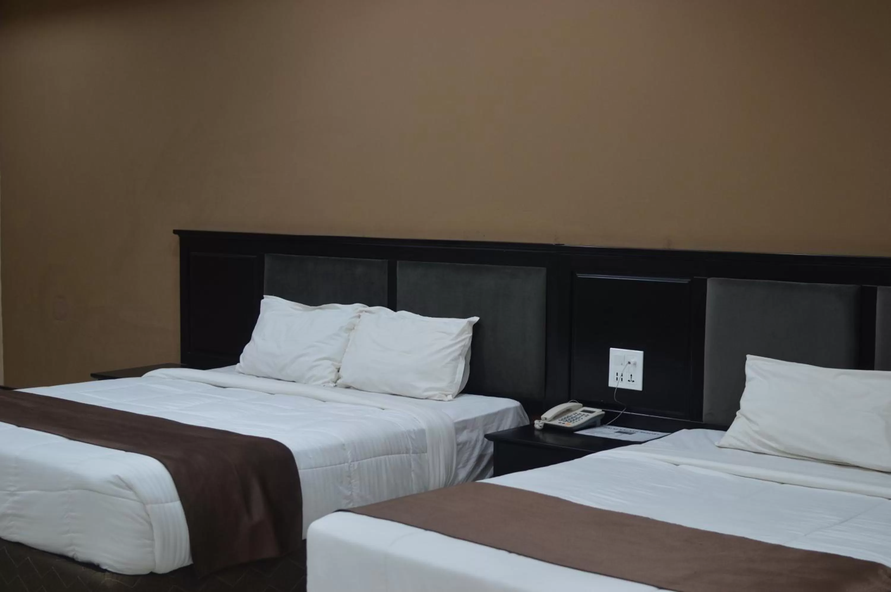 Bed in Palm Kalash Hotel