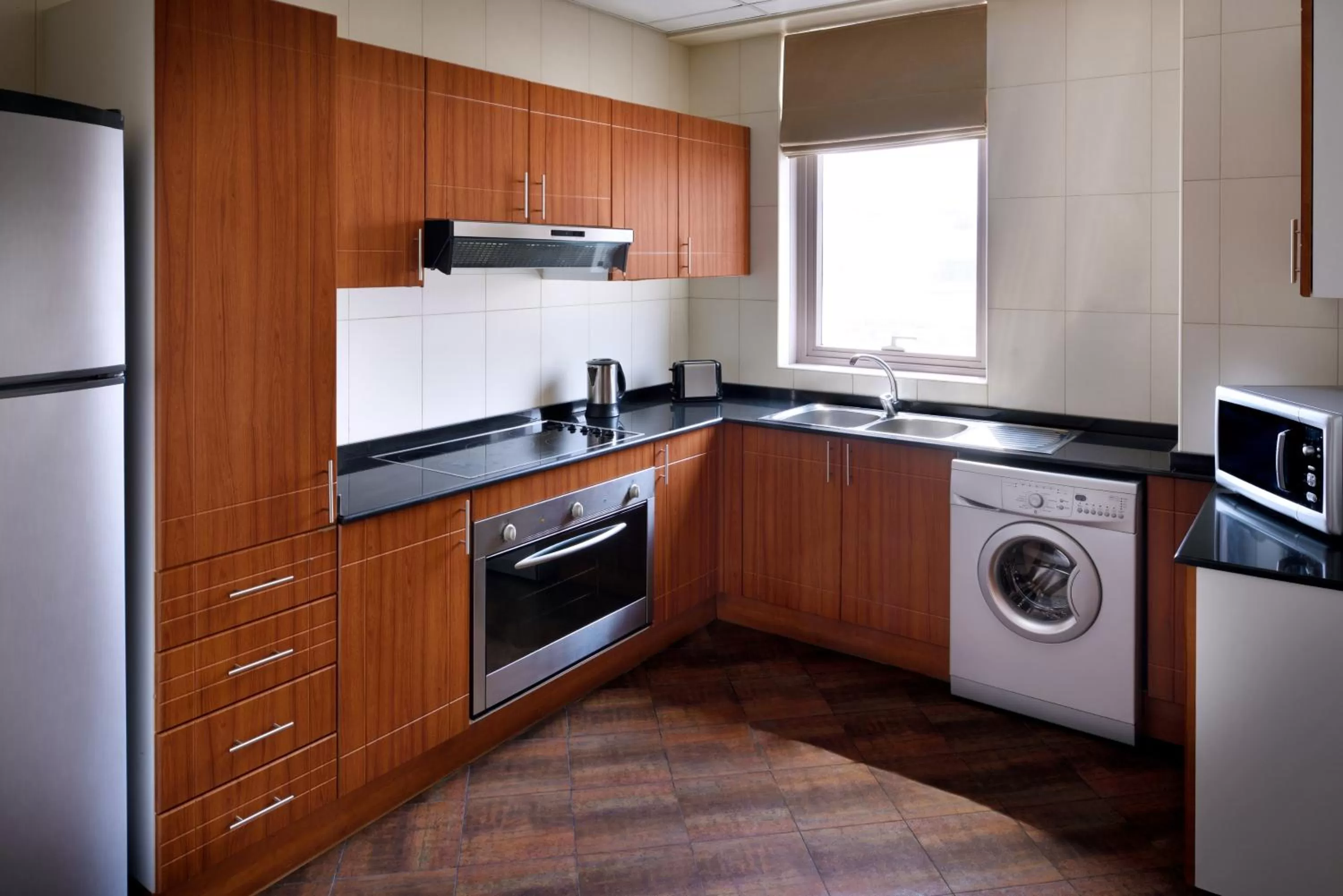 Kitchen or kitchenette in Mövenpick Hotel & Apartments Bur Dubai