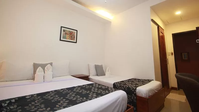 Bed in El Nido Royal Palm Inn