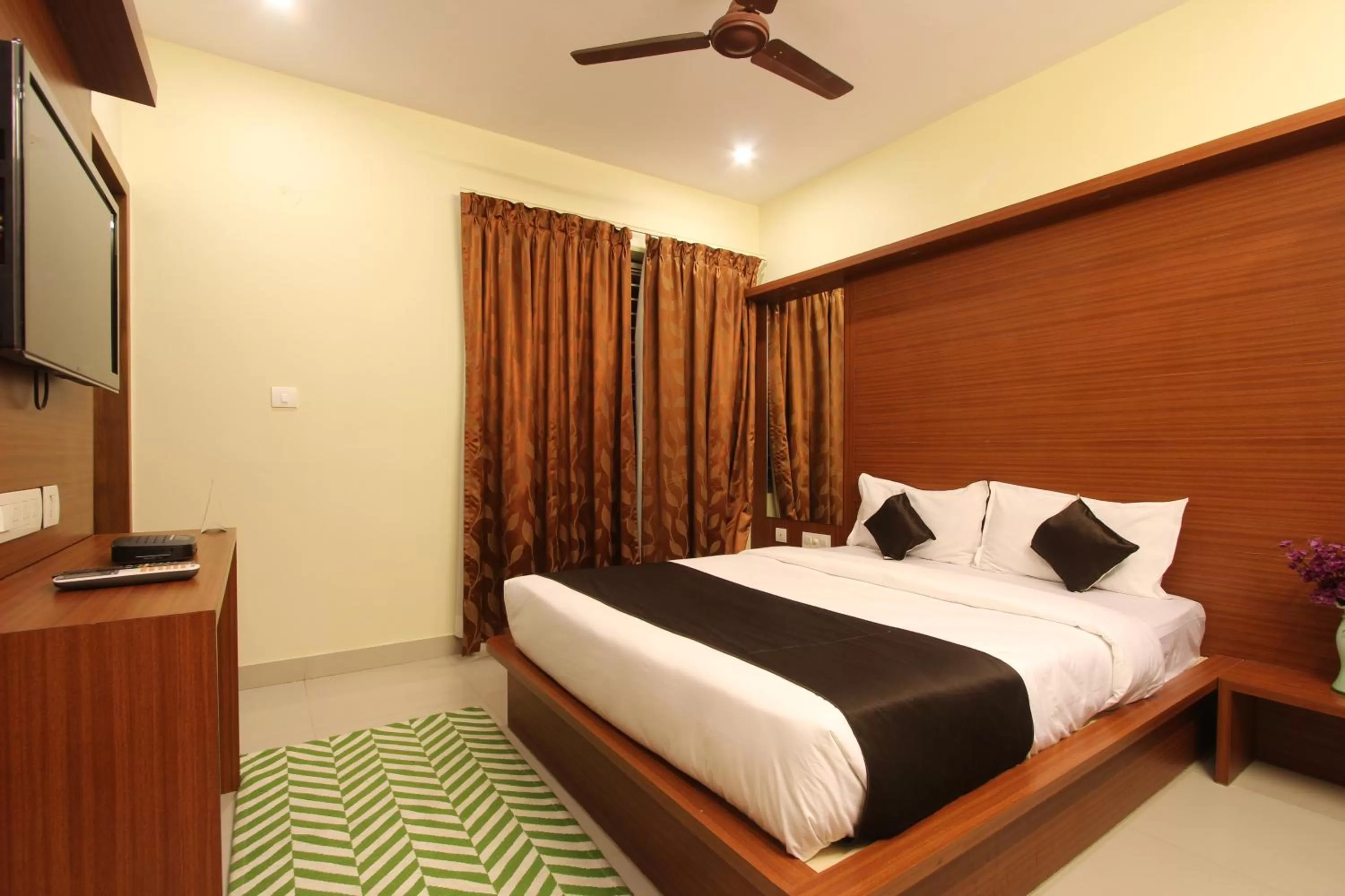 Bed in The Grand Inn Mysore