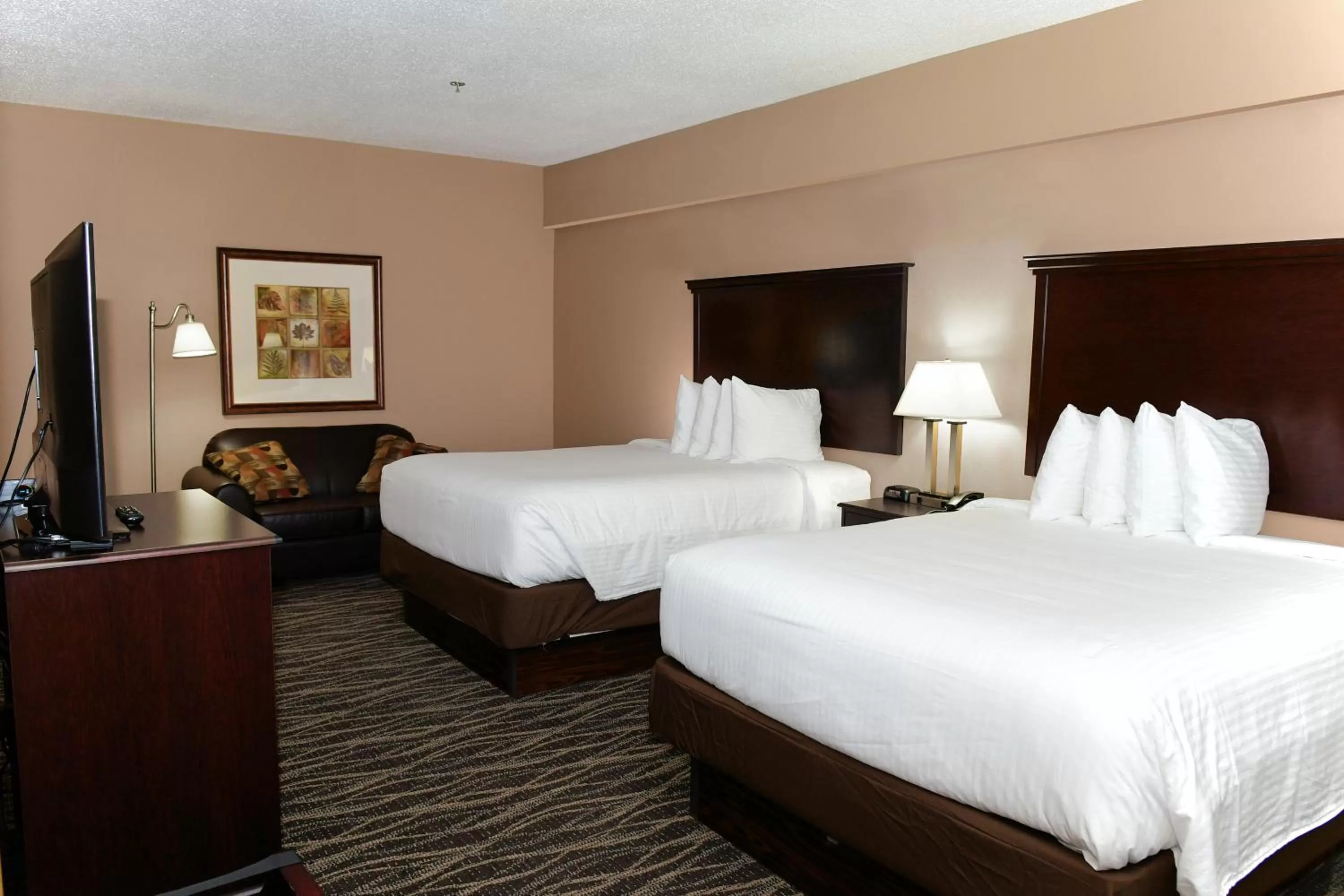 Bed in Cobblestone Inn & Suites - Denison | Majestic Hills