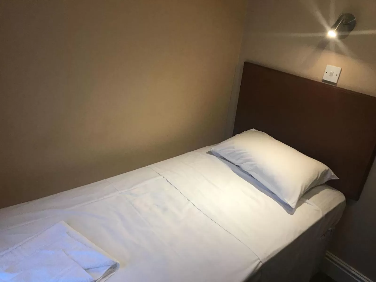 Bed in Ambassador Hotel