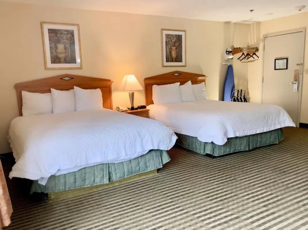 Bed in Whitney Inn & Suites