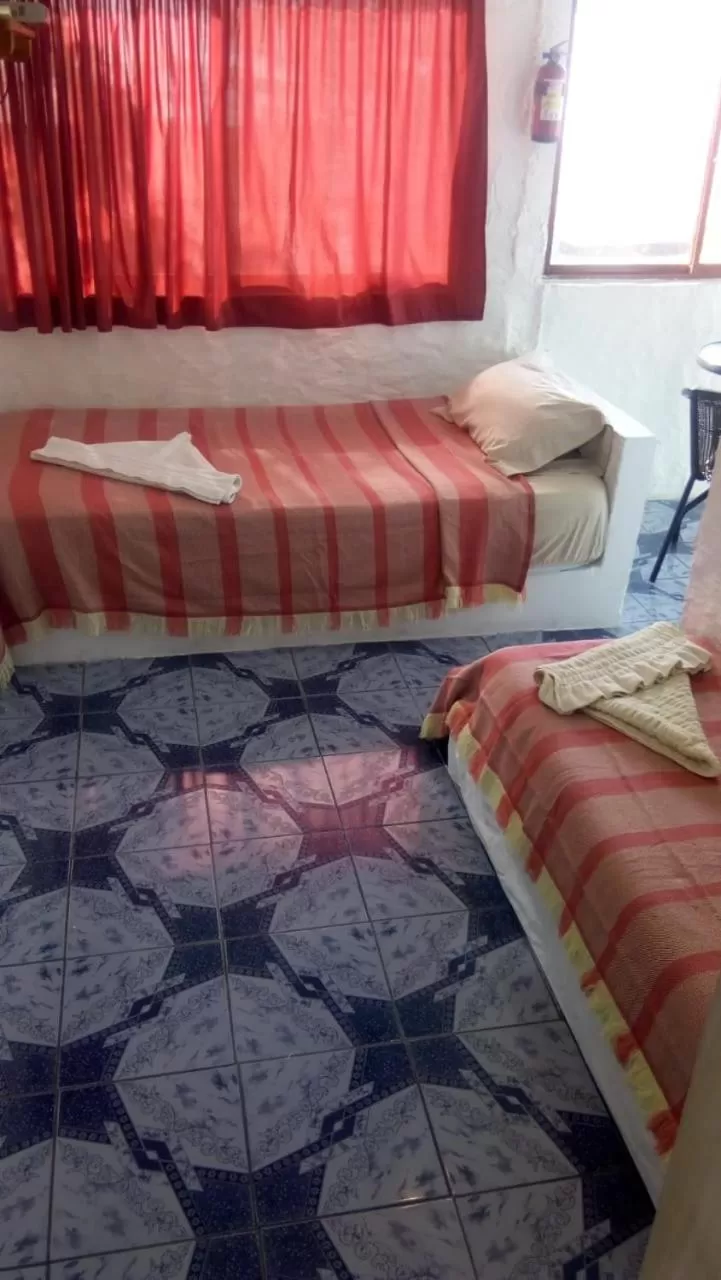 Bed in Hostal Cabañas Don Jorge