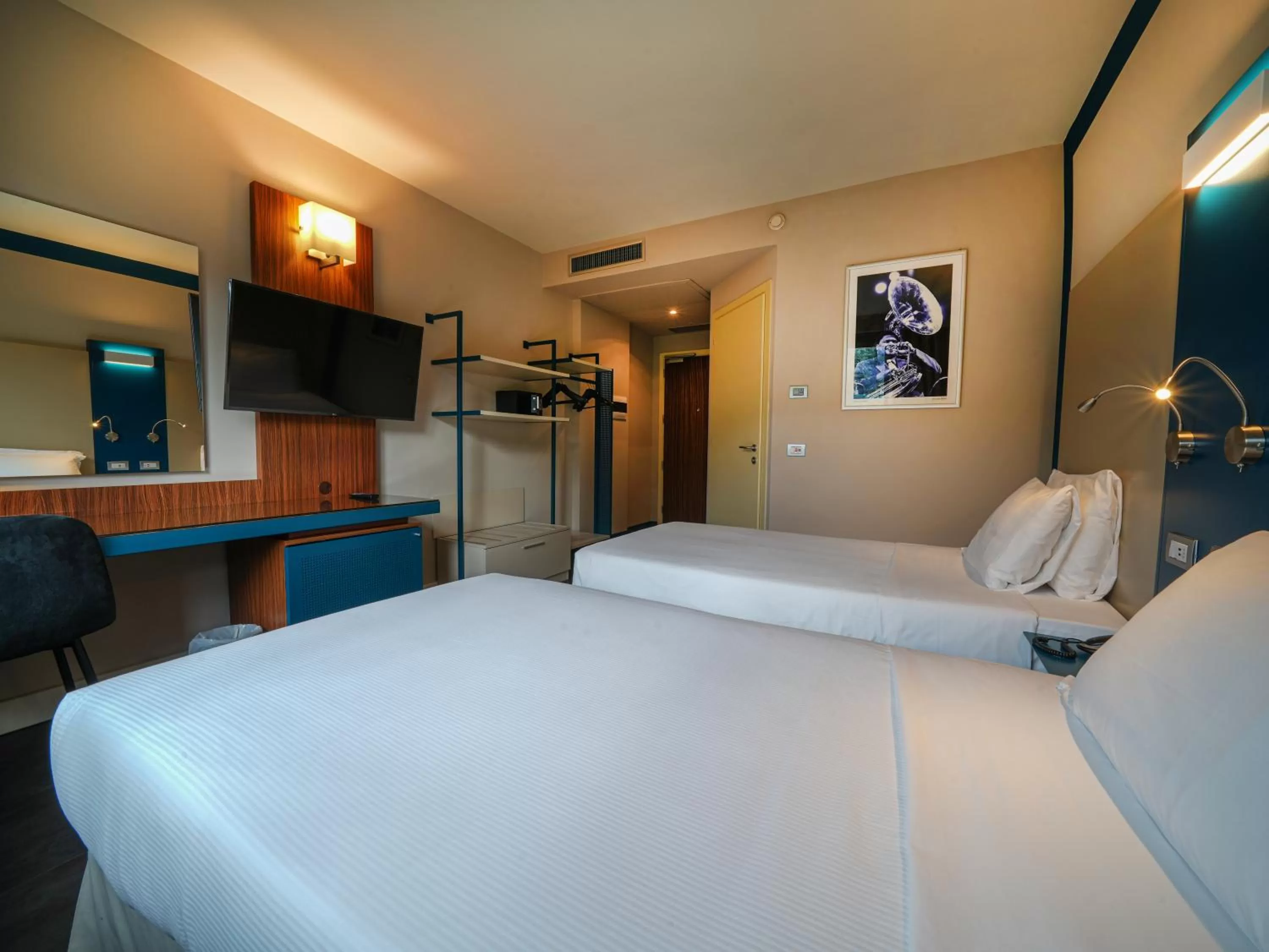 Bed in La Meridiana Bleisure Hotel