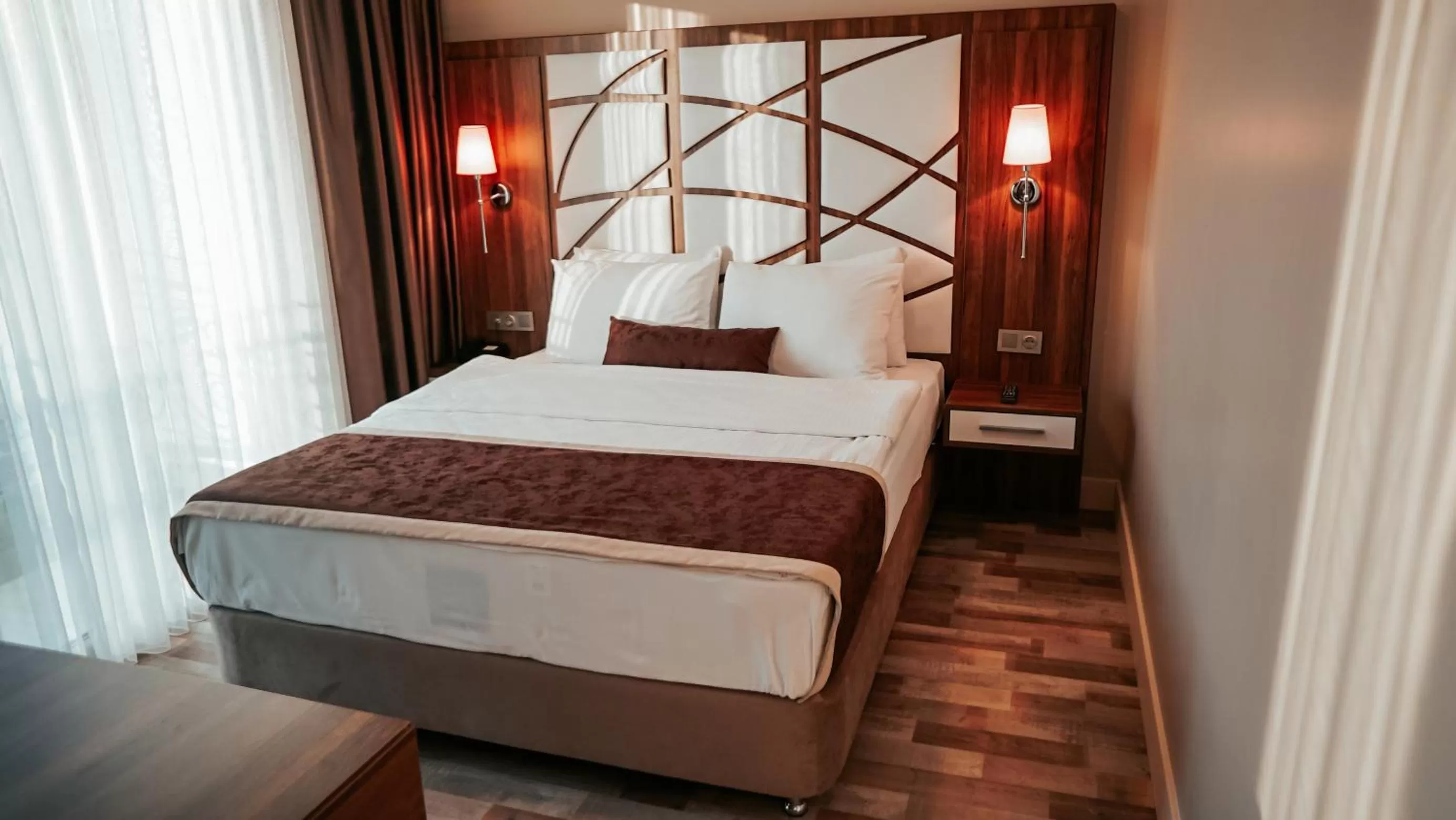 Bed in The Grand Mira Business Hotel