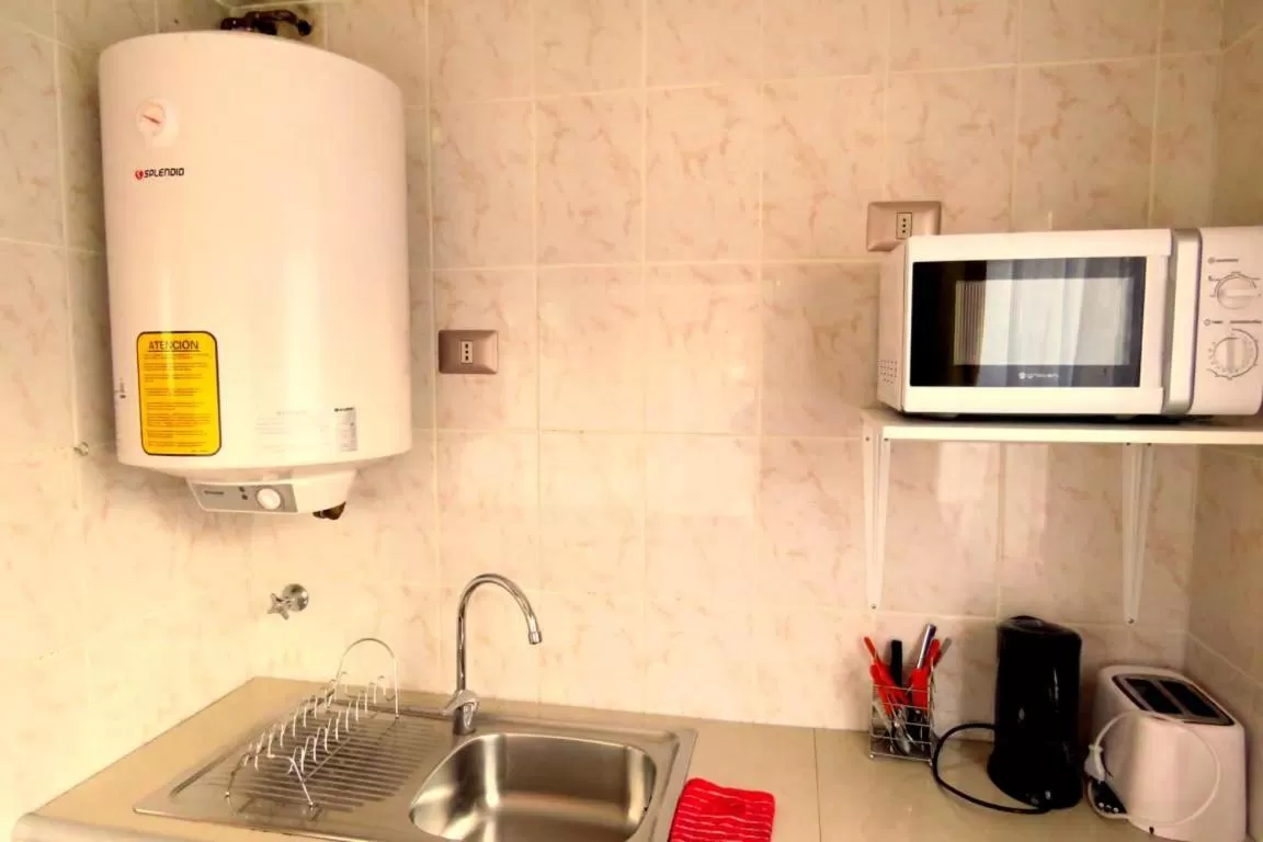 Kitchen or kitchenette, Kitchen/Kitchenette in Apart-Hotel Colonia-Königsberg ESTACIONAMIENTO Deptos Completos Ubicado En El Centro De Valdivia AIRE ACONDICIONADO