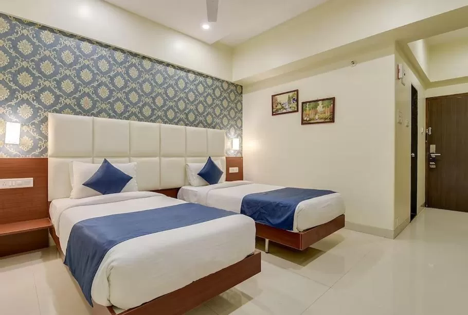 Bed in Magnus Square Business Hotel near Pune Airport