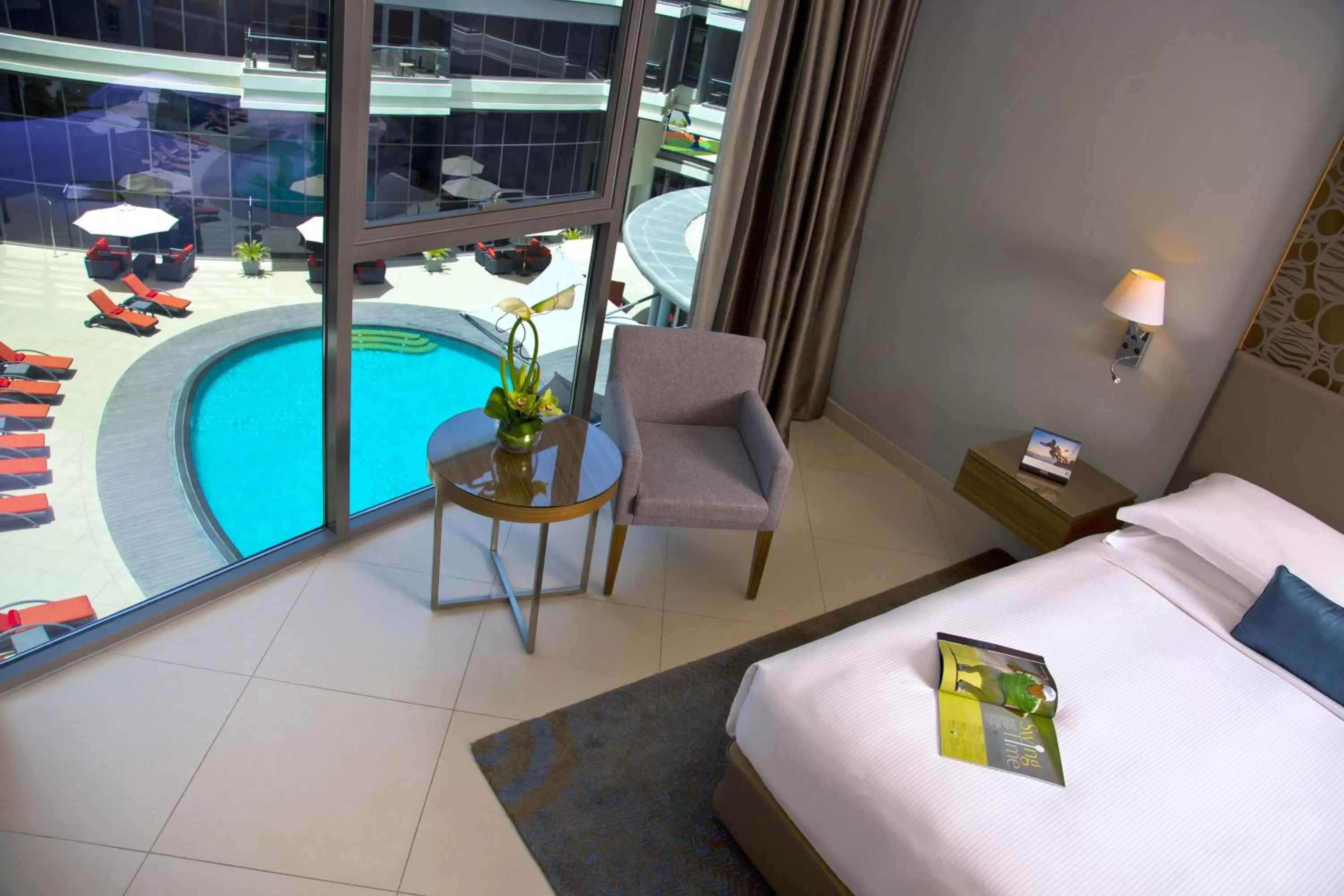 Pool view, Bed in Majestic Arjaan by Rotana – Manama