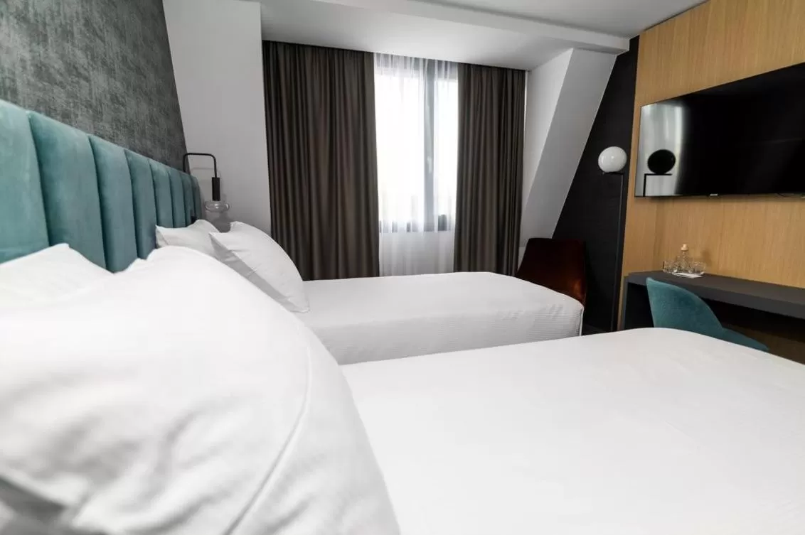 Bed in Elegans Hotel Brdo