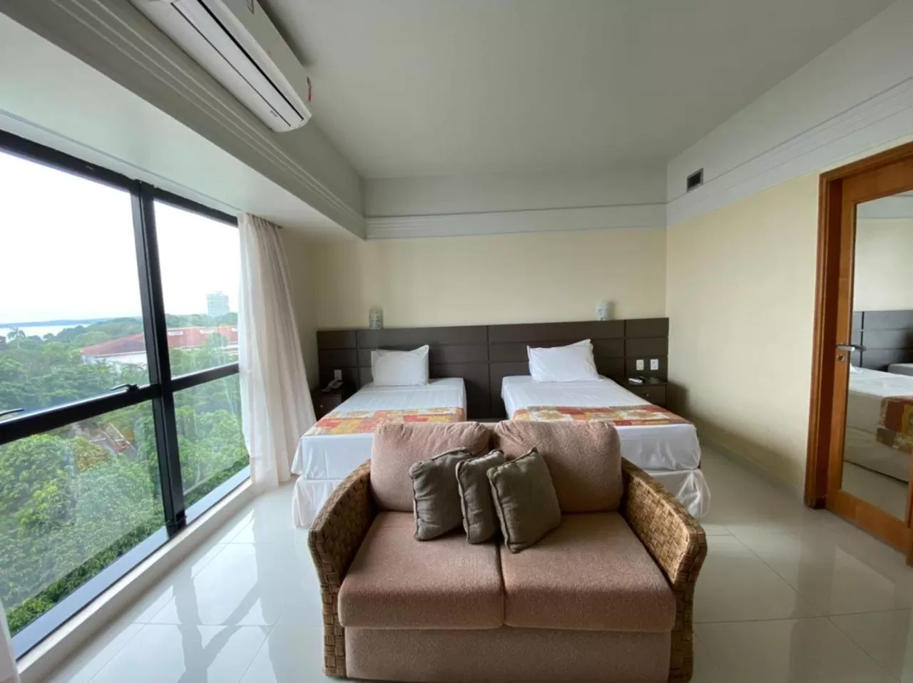 Bed in Tropical Executive Hotel