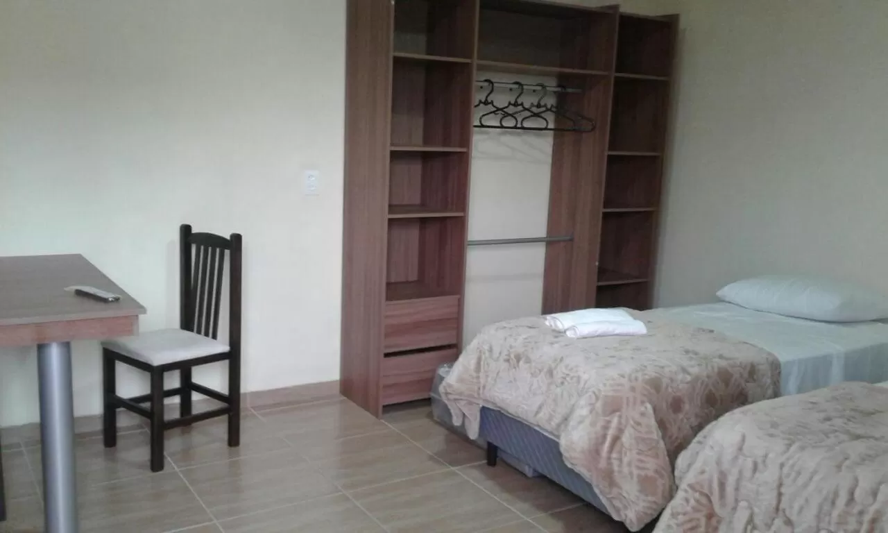 Bed in Pousada Mercosul