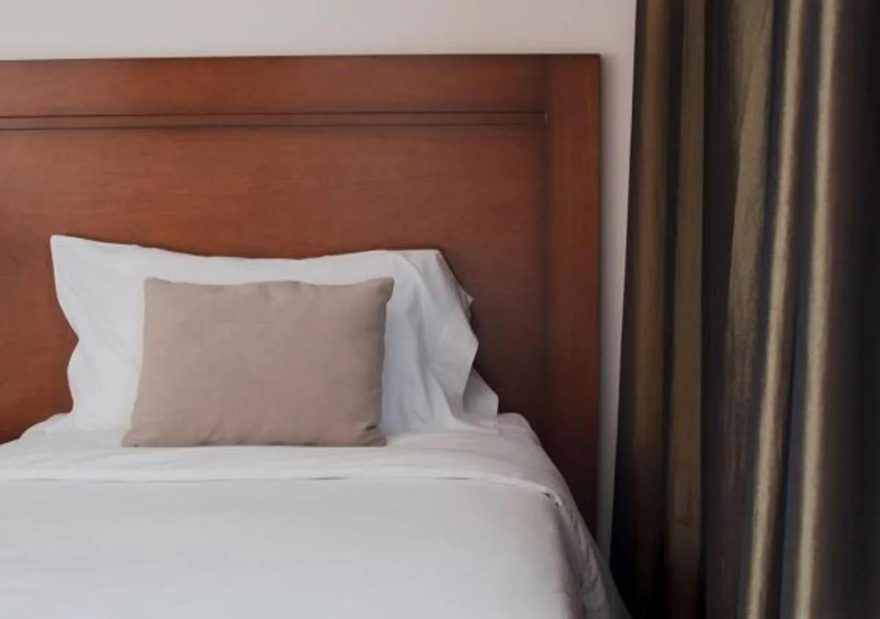 Bed in Herradura Hotel Suites