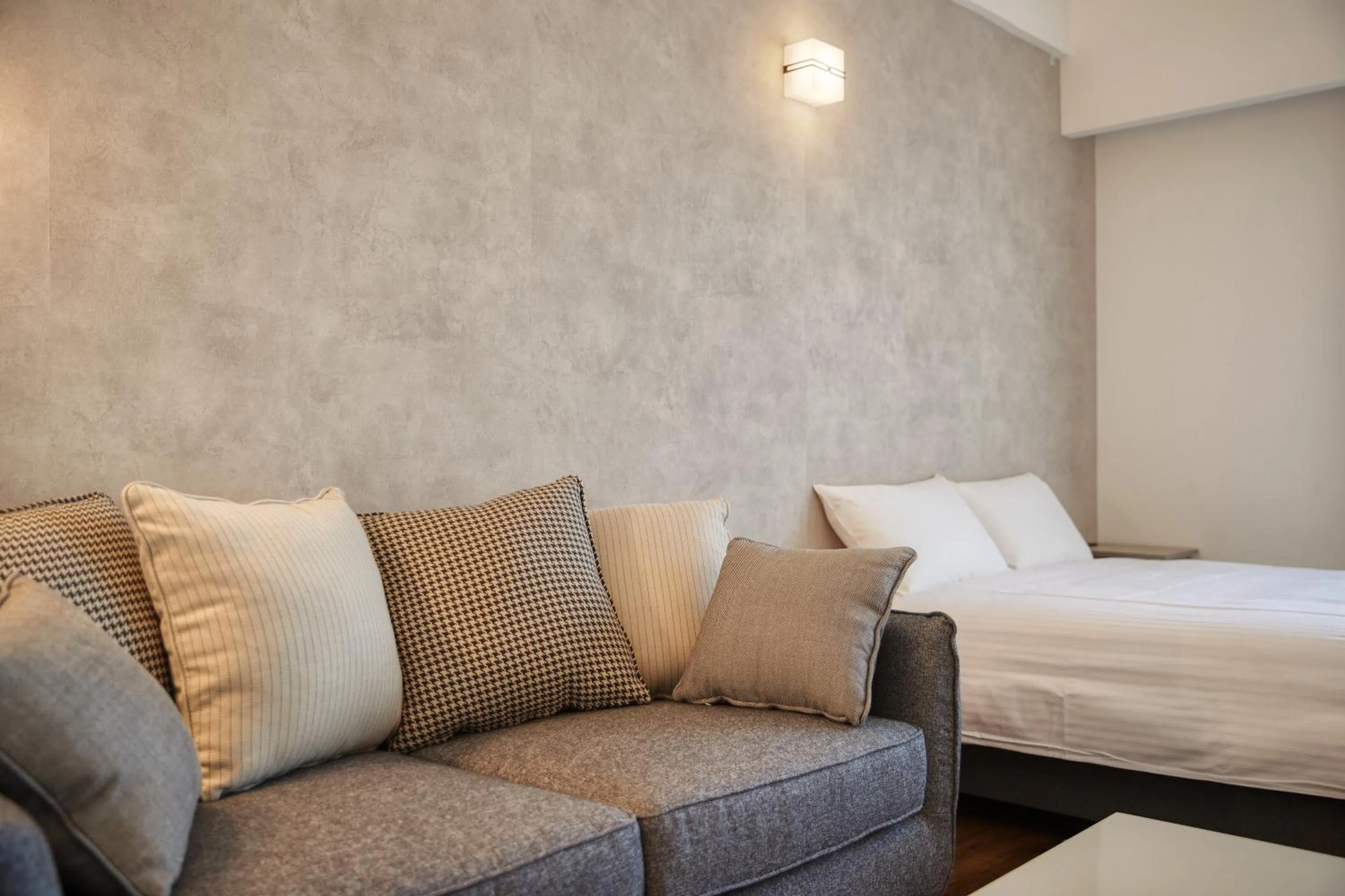 Photo of the whole room, Bed in New Normal Hotel in NAMINOUE ニューノーマルホテルイン波の上