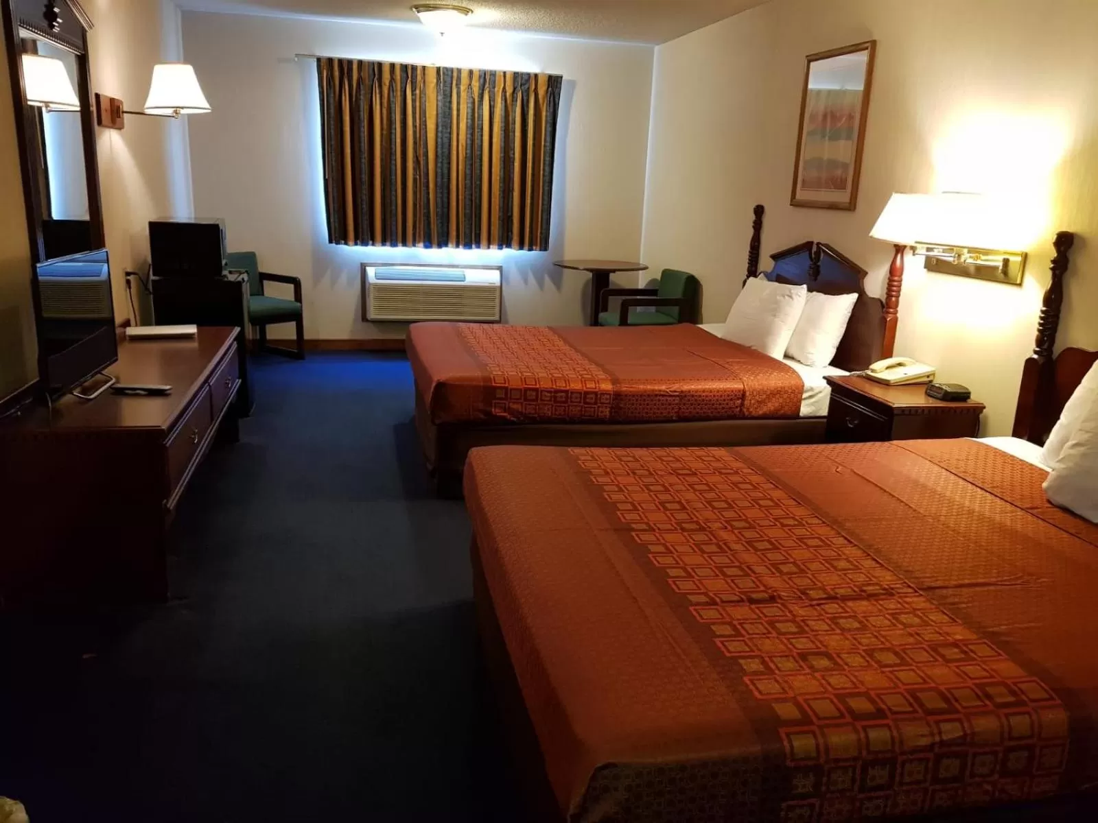 Bed in Denison Inn & Suites