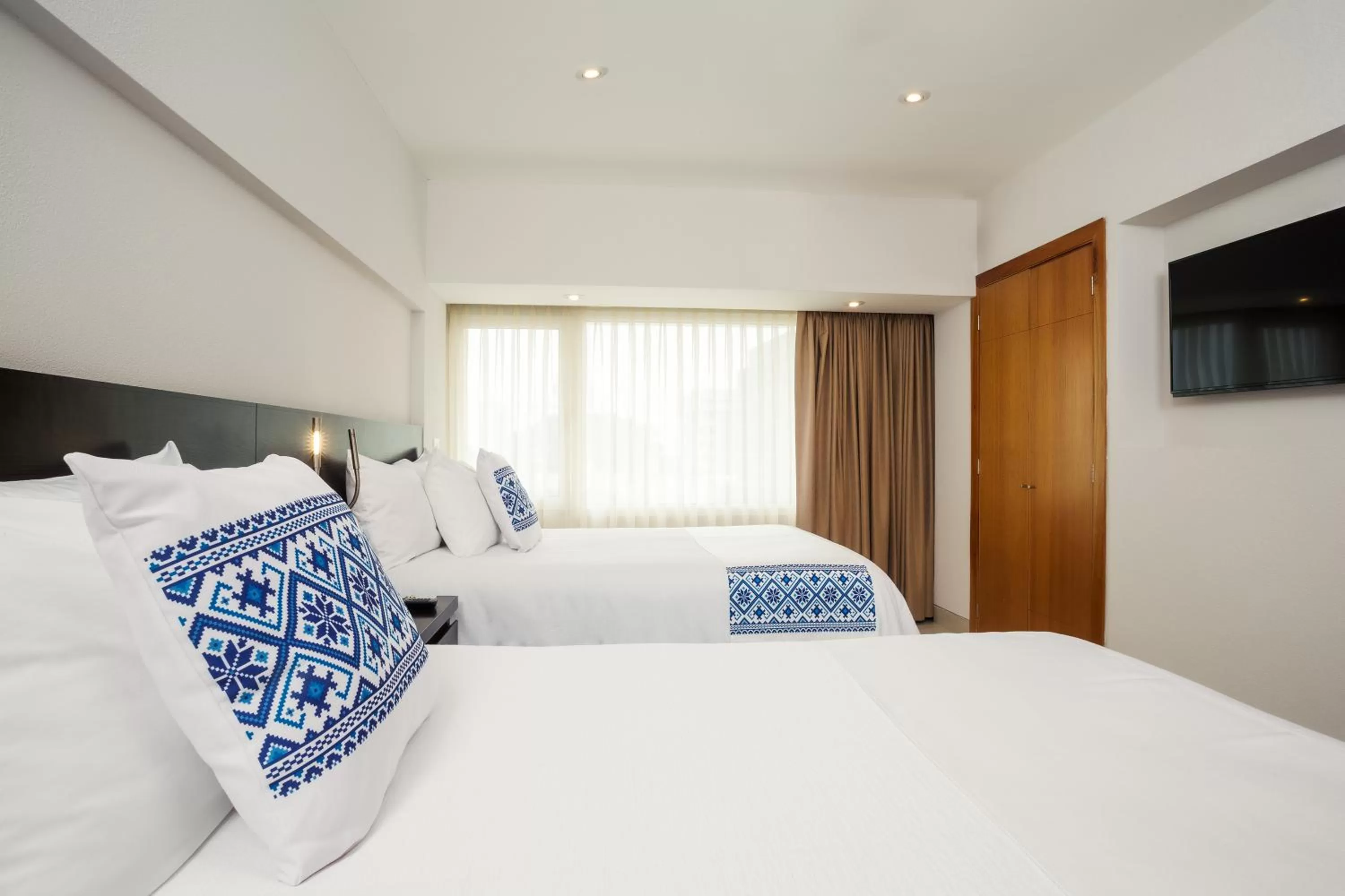 Bed in Hotel Indigo Guadalajara Expo by IHG