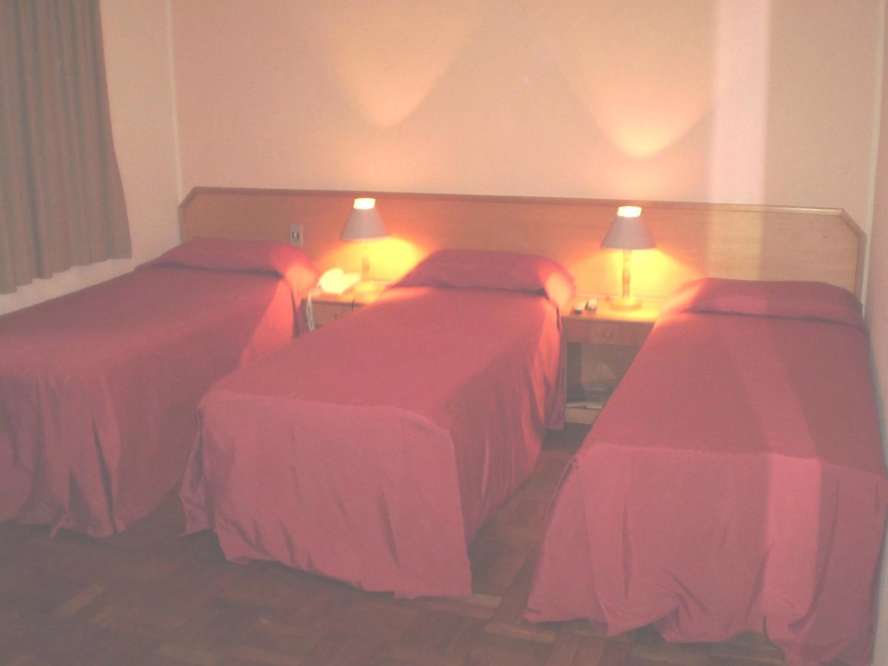 Bed in Hotel Gravataí Center