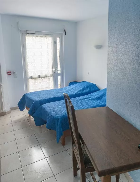 Bed in HOTEL DU CYGNE DE LA CROIX BLANCHE