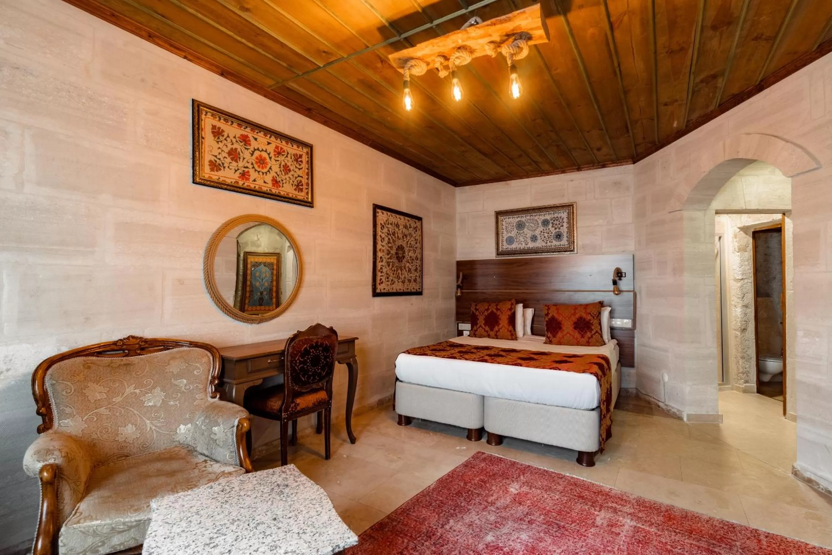 Seating area, Bed in Amber Cave Suites
