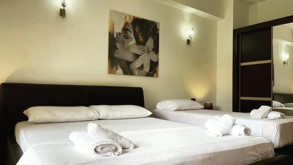 Bed in Hotel Ambasador Garden