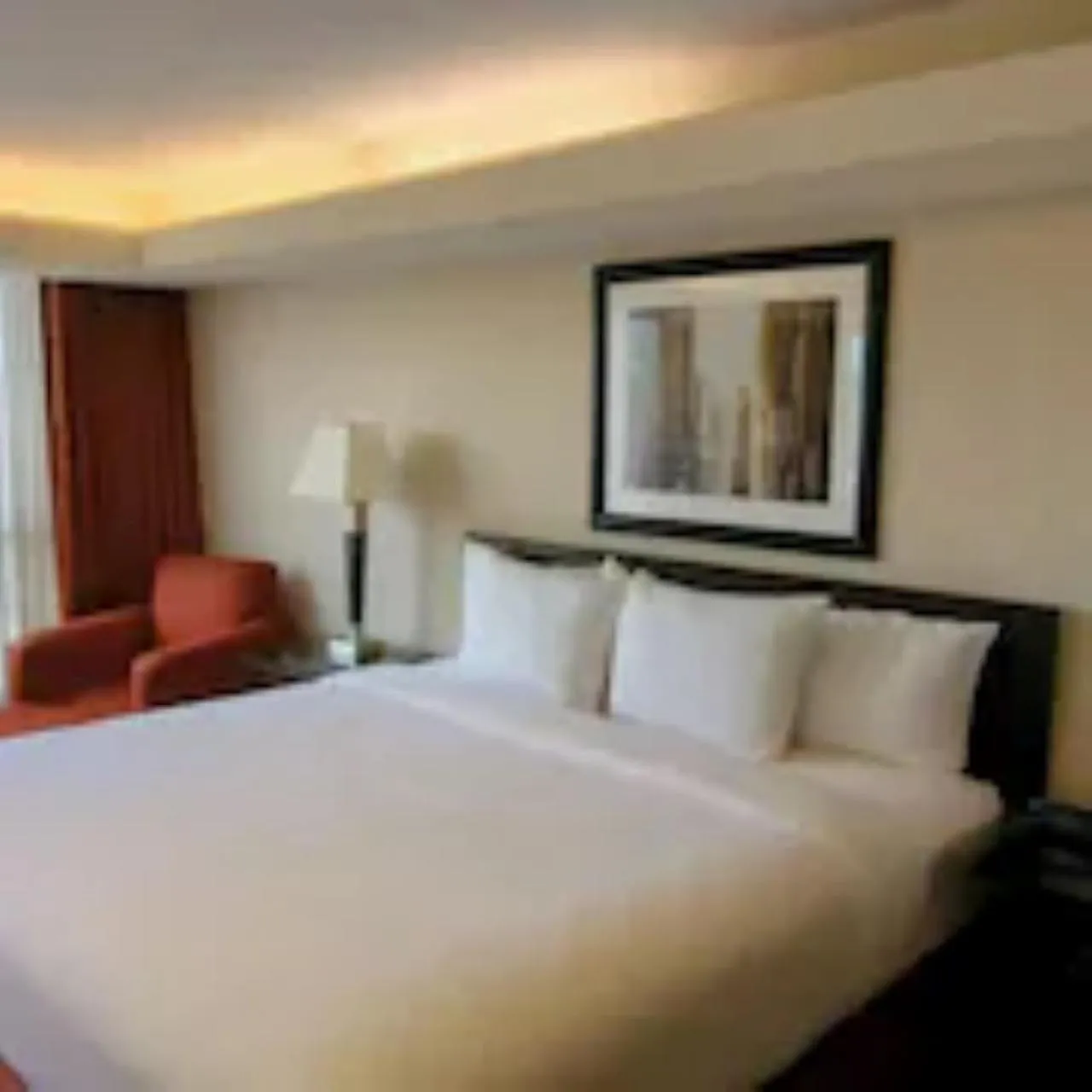 Bed in Hotel Lotus Kansas City Merriam