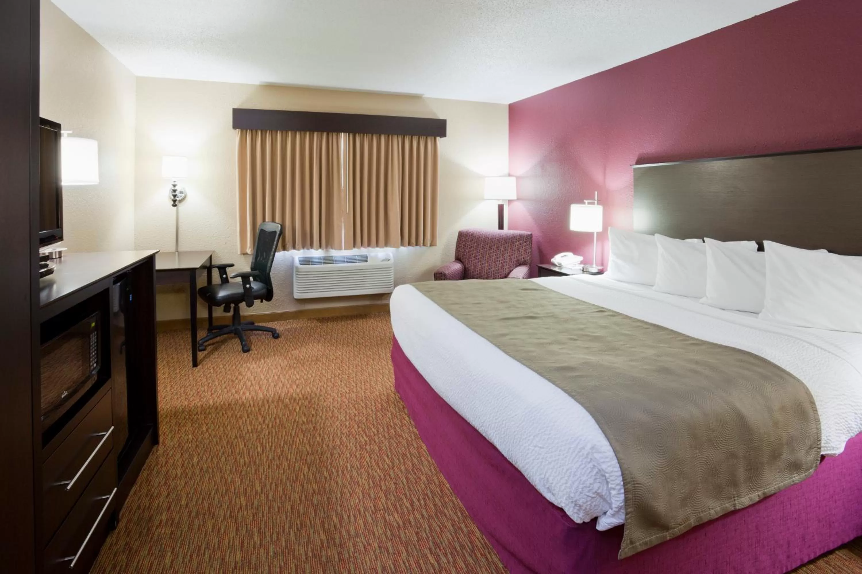 Bed in AmericInn by Wyndham Osceola