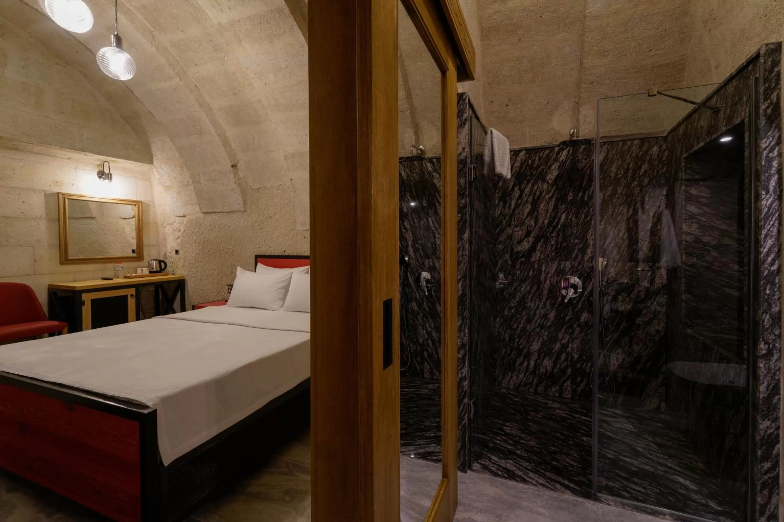 Shower, Bed in The Niche Cave Hotel