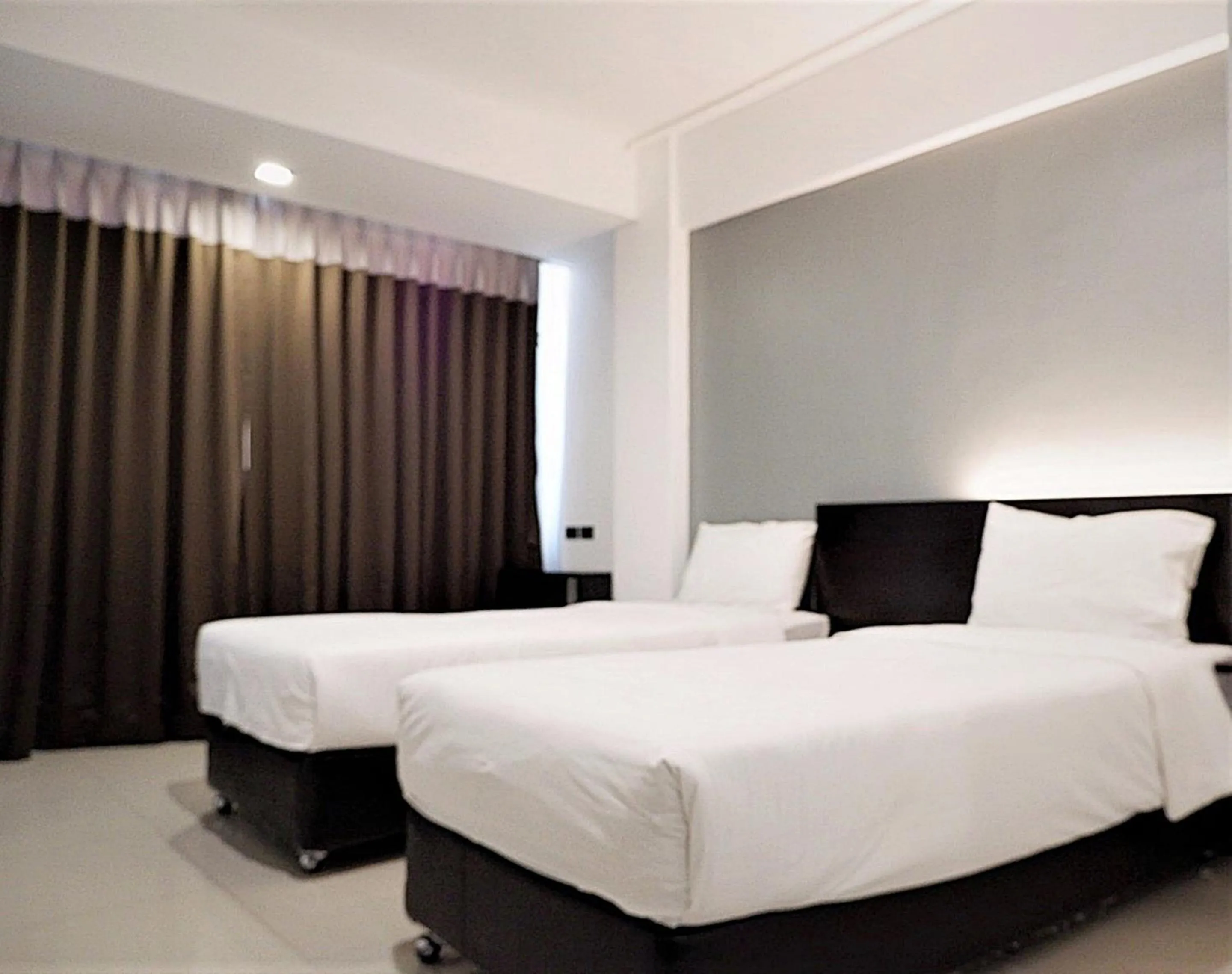 Bed in Izen Budget Hotel & Residence