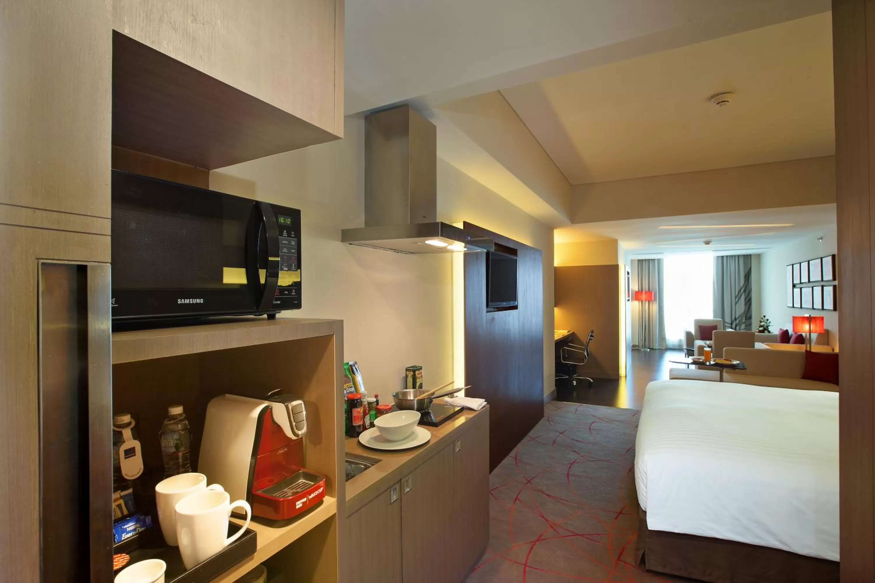 Kitchen or kitchenette, Bed in Novotel Ahmedabad
