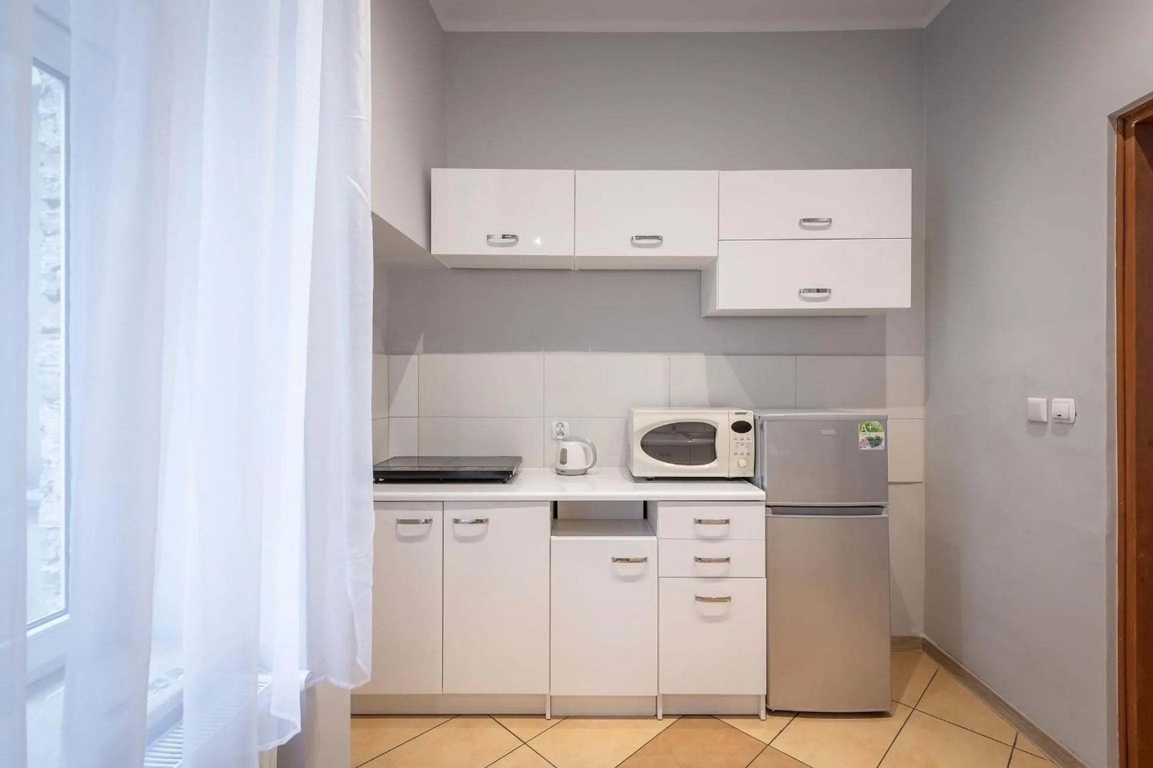 Kitchen or kitchenette in Queen Apartments