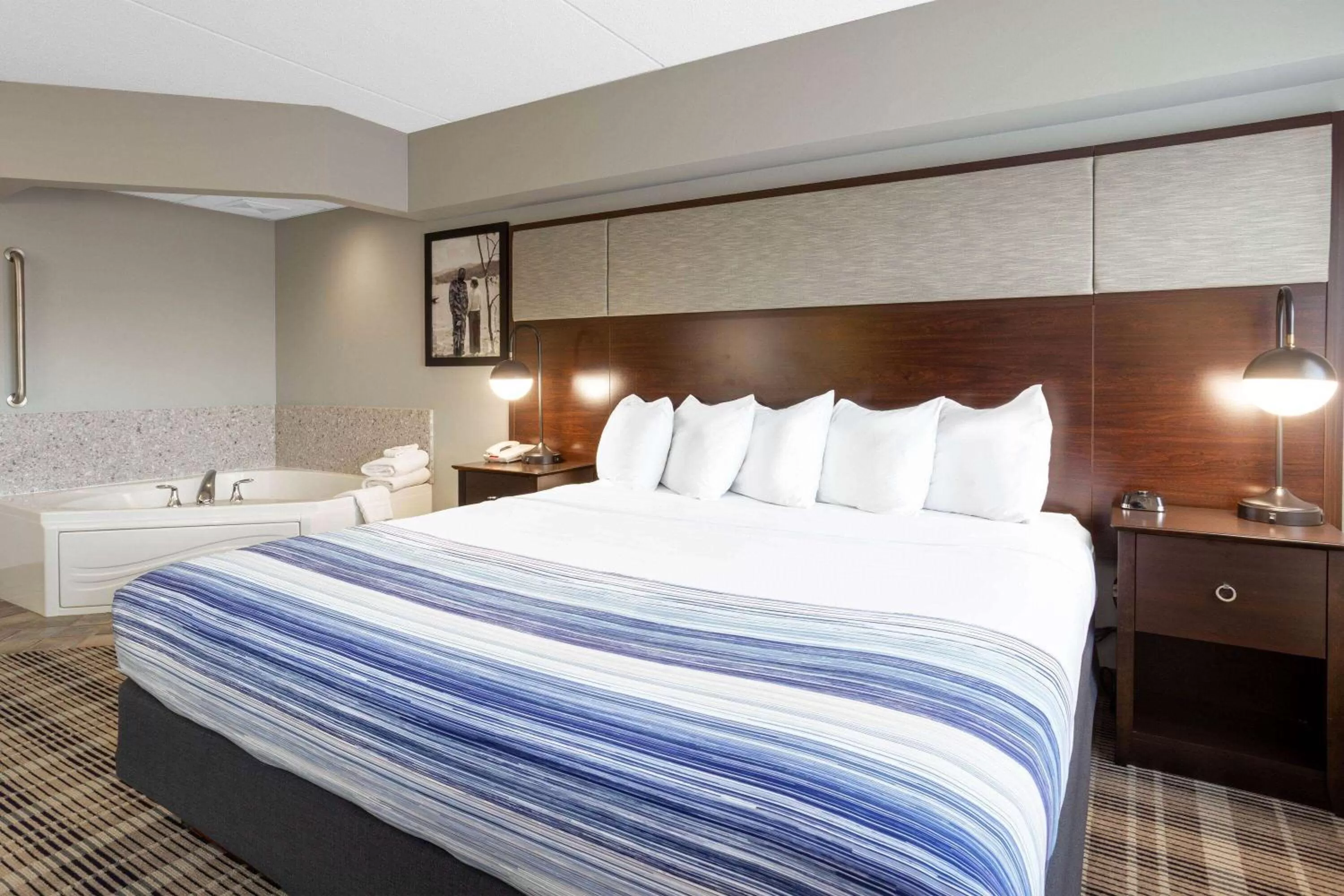 Bed in AmericInn by Wyndham Madison South