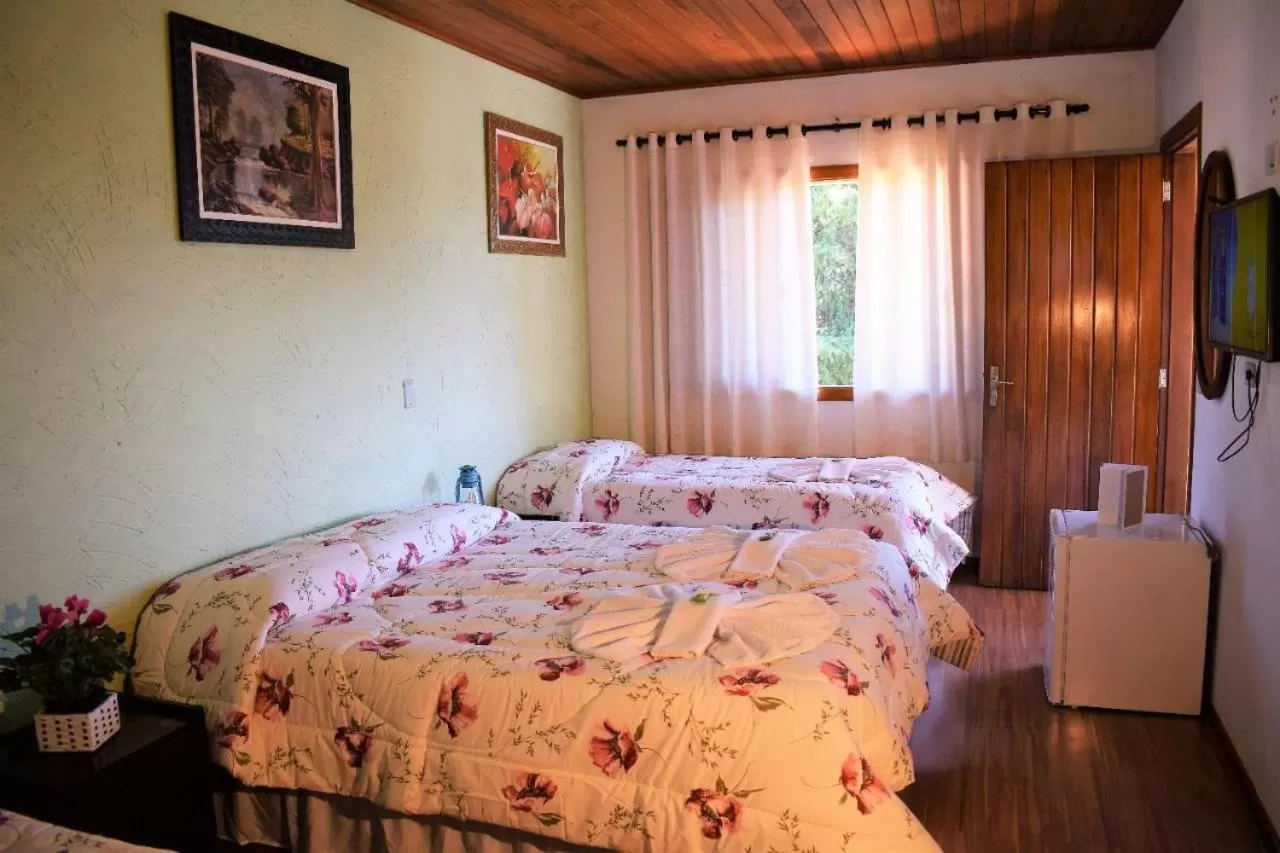 Bed in Pousada Curumi