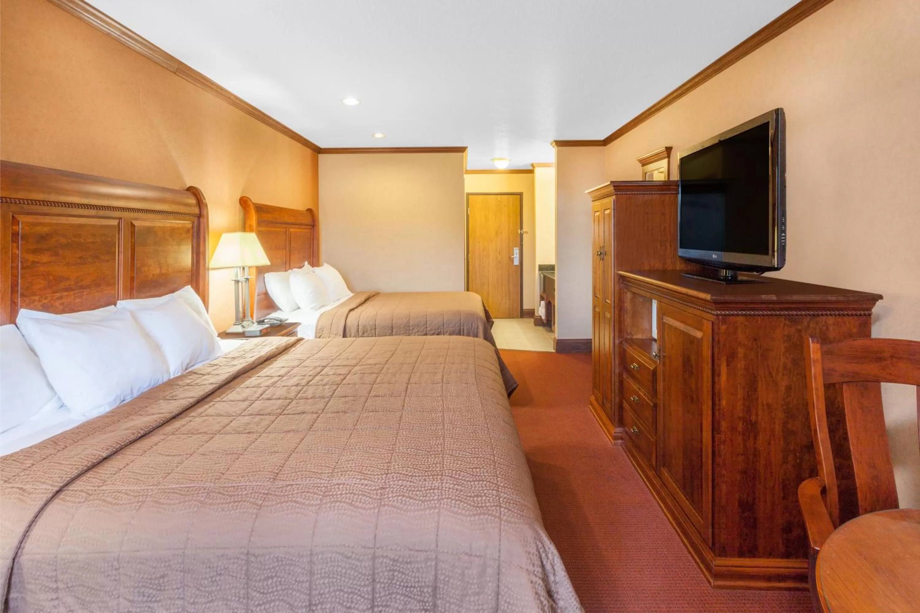 Photo of the whole room, Bed in Ramada by Wyndham Mackinaw City Waterfront