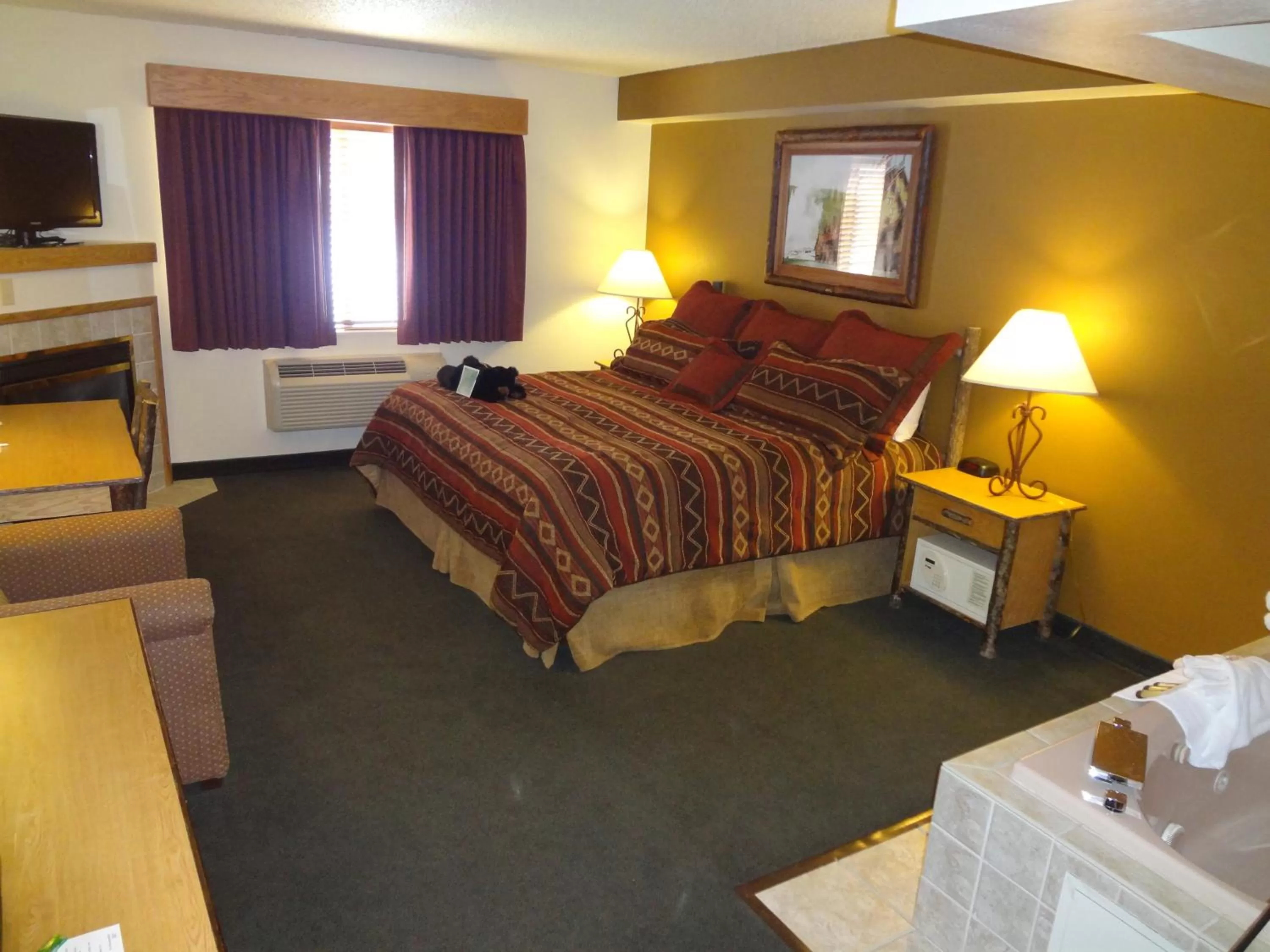 Bed in AmericInn by Wyndham Cody