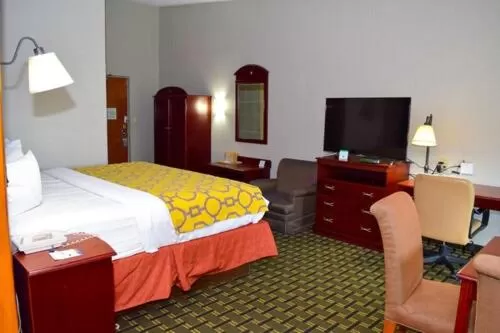 Seating area, Bed in Baymont by Wyndham Michigan City