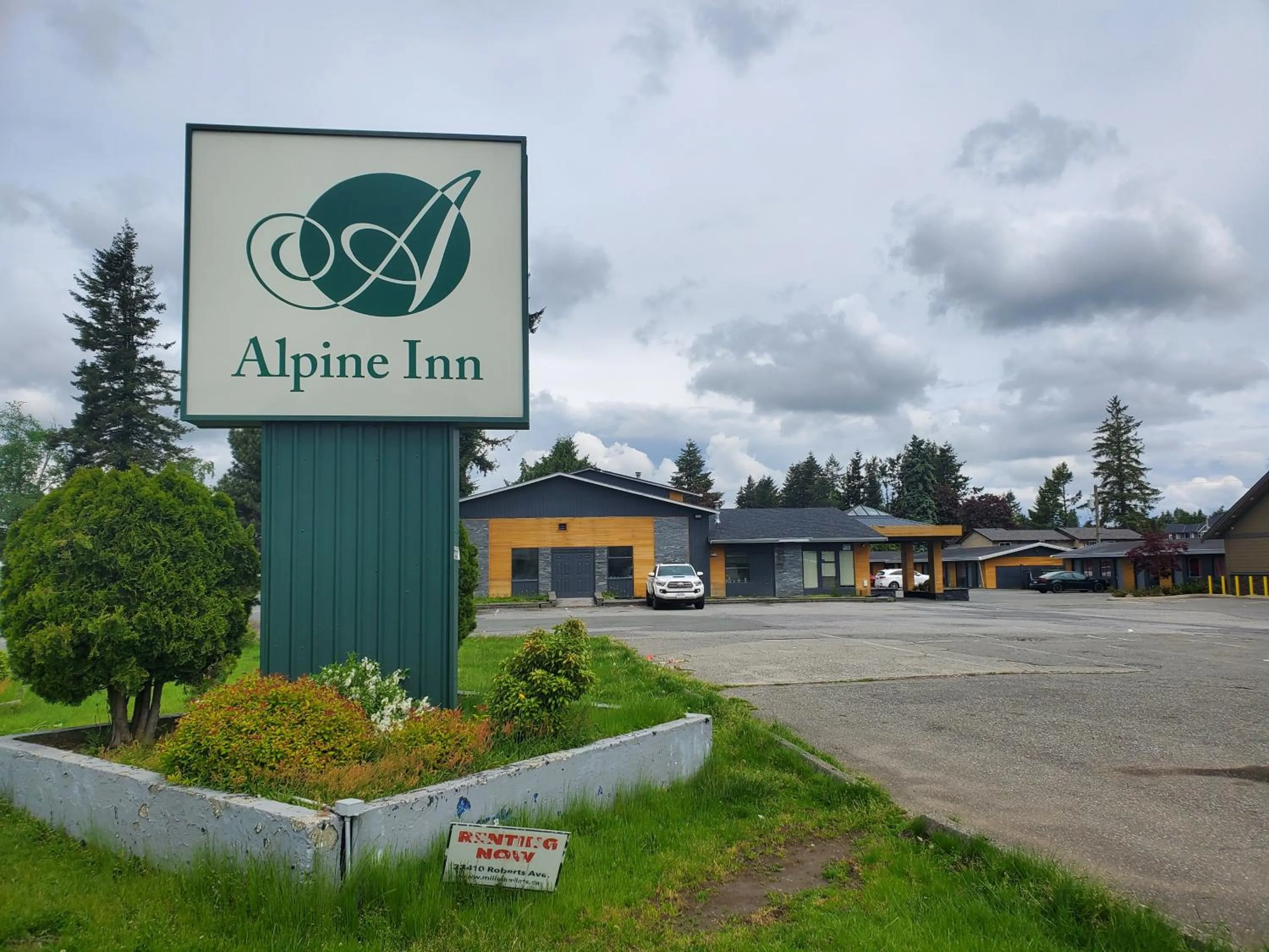 Property logo or sign in Alpine Inn Abbotsford