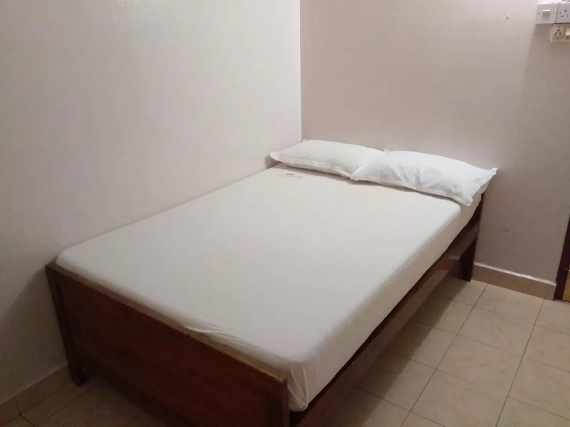 Bed in Anandan Tourist Home