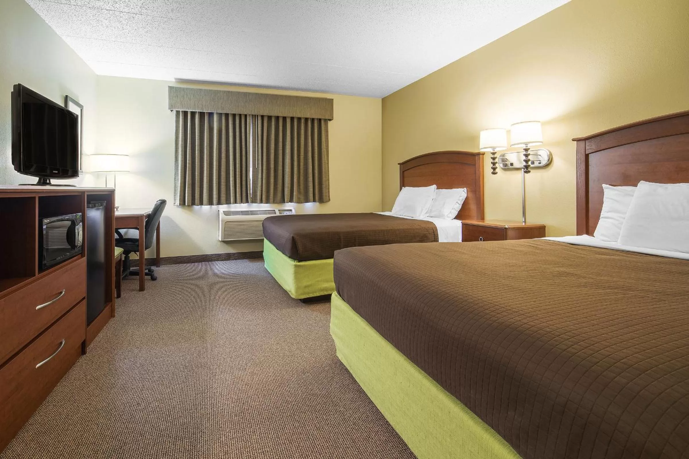 Bed in AmericInn by Wyndham Sioux Falls