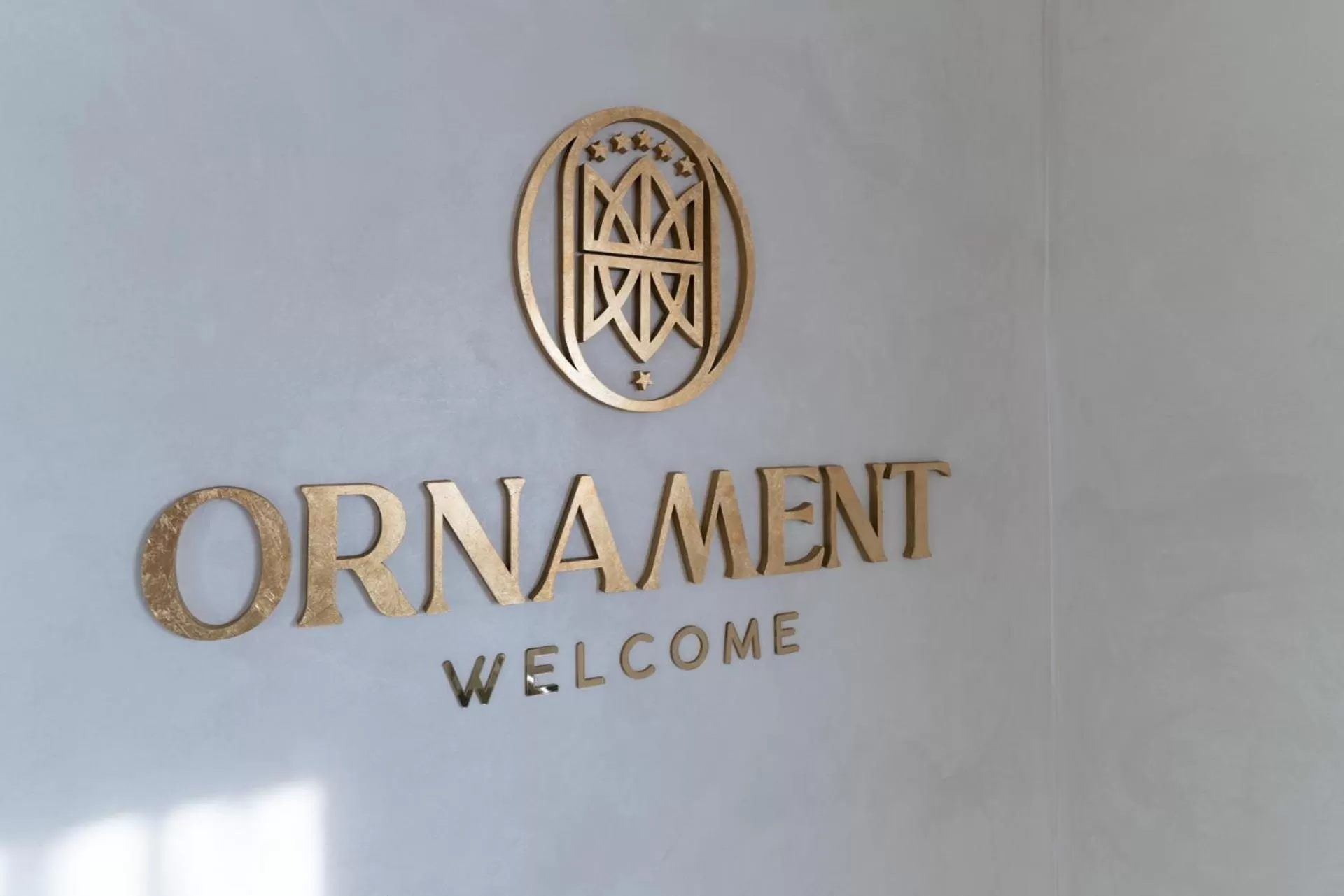 Property logo or sign in Ornament Hotel and Apartments