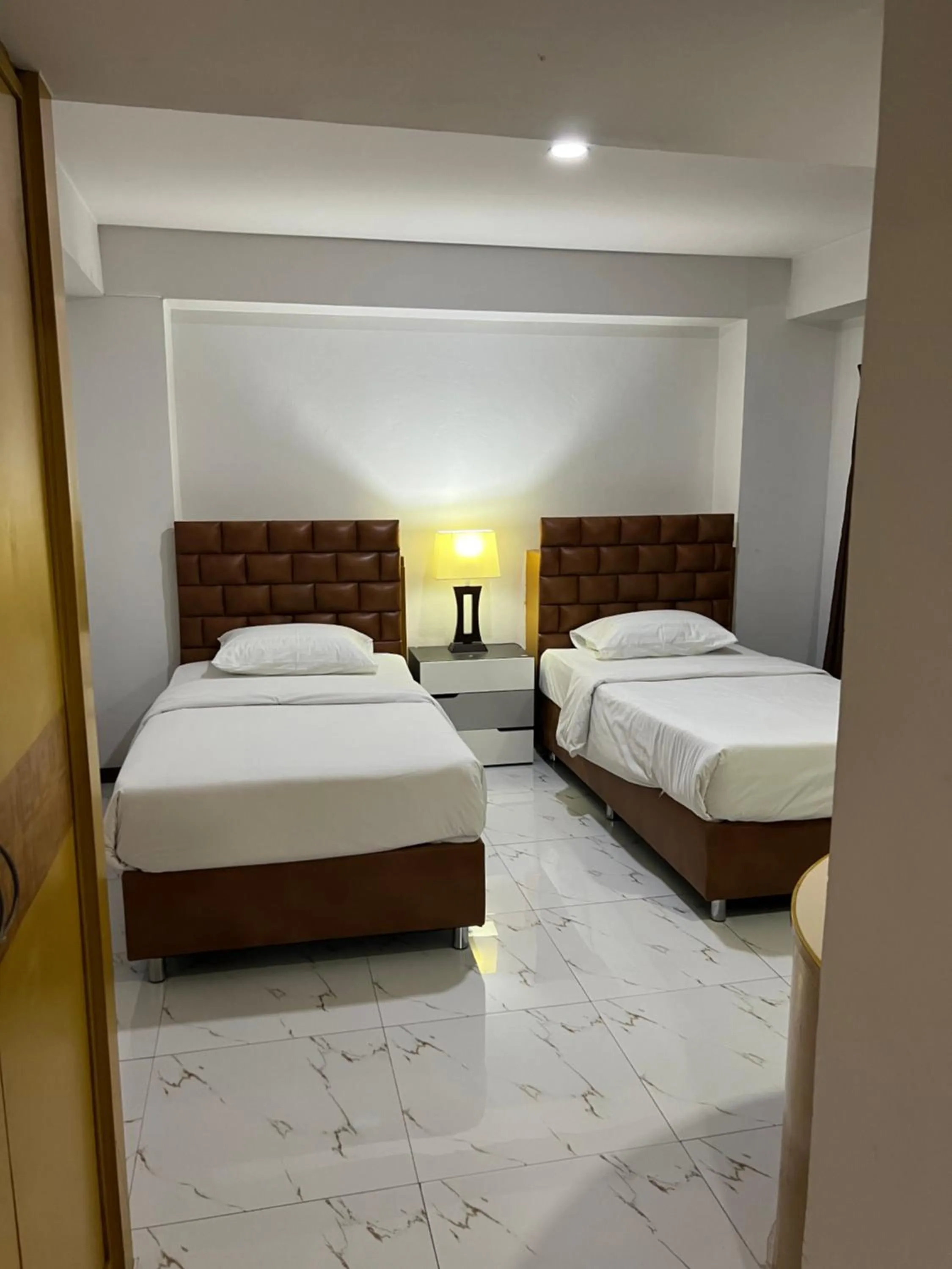 Bed in Mall Suites Hotel