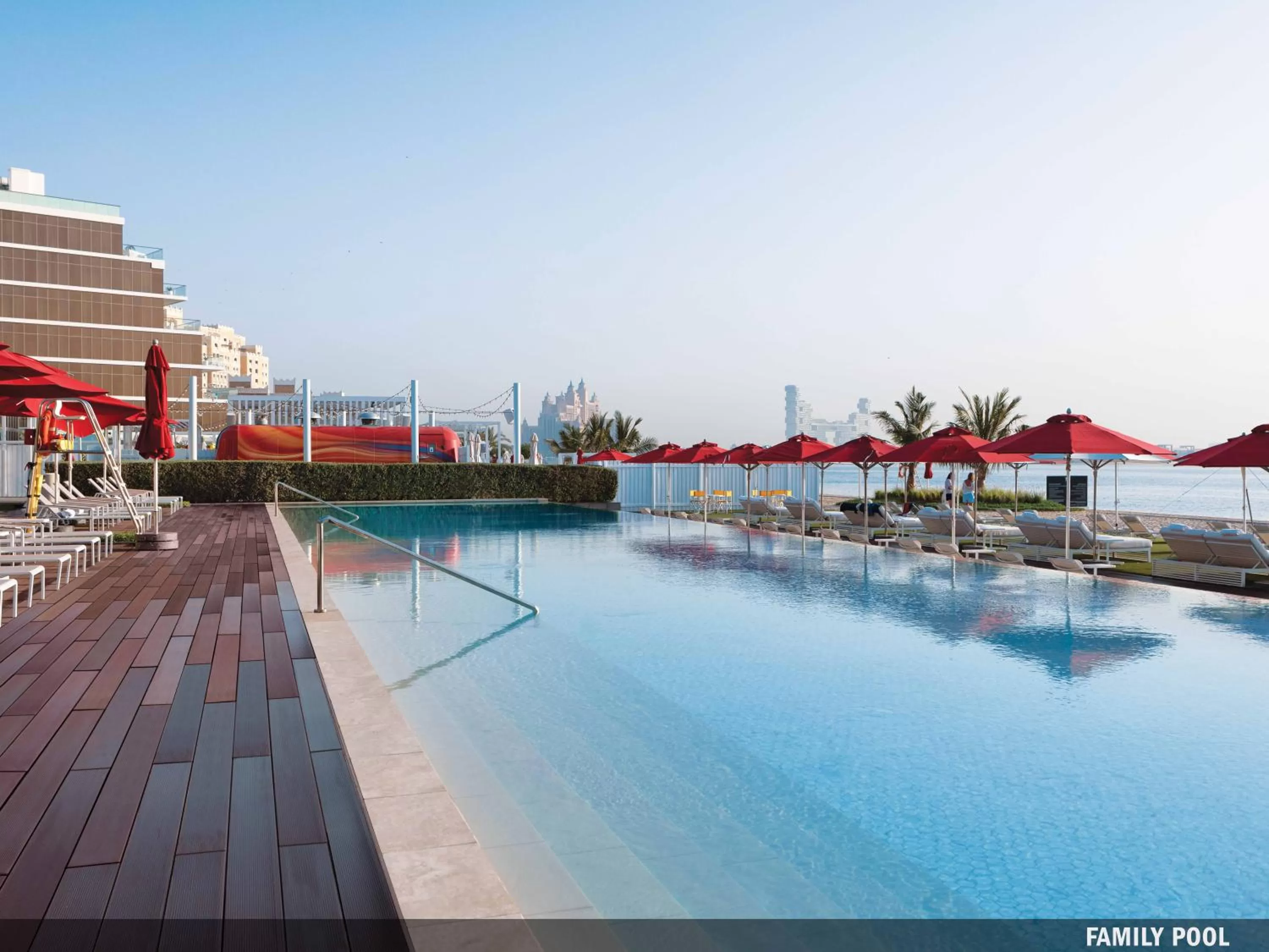 Swimming pool in Th8 Palm Dubai Beach Resort Vignette Collection, an IHG hotel