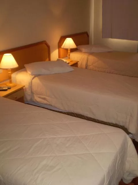 Bed in Hotel Gravataí Center