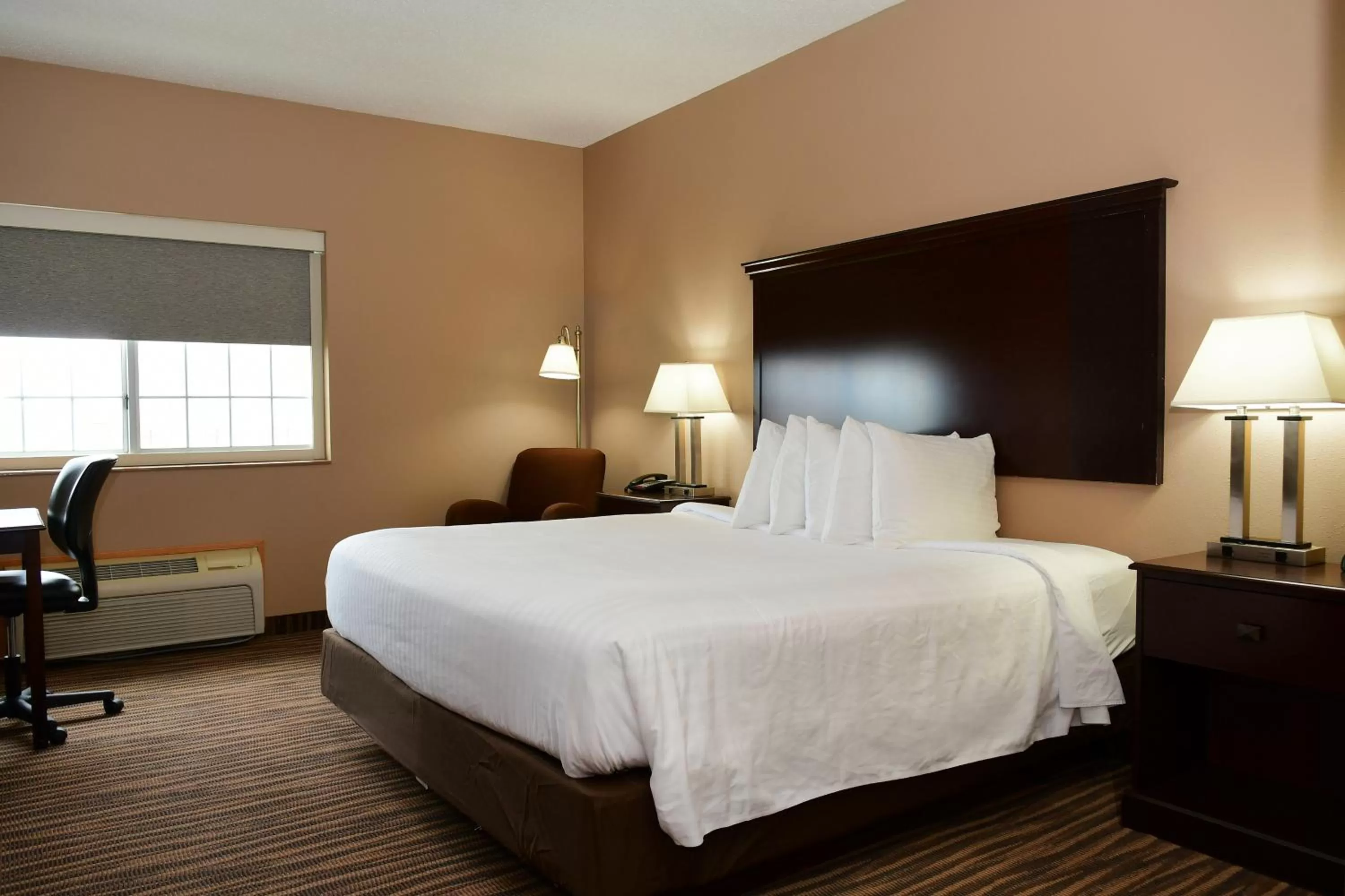 Bed in Cobblestone Inn & Suites - Denison | Majestic Hills