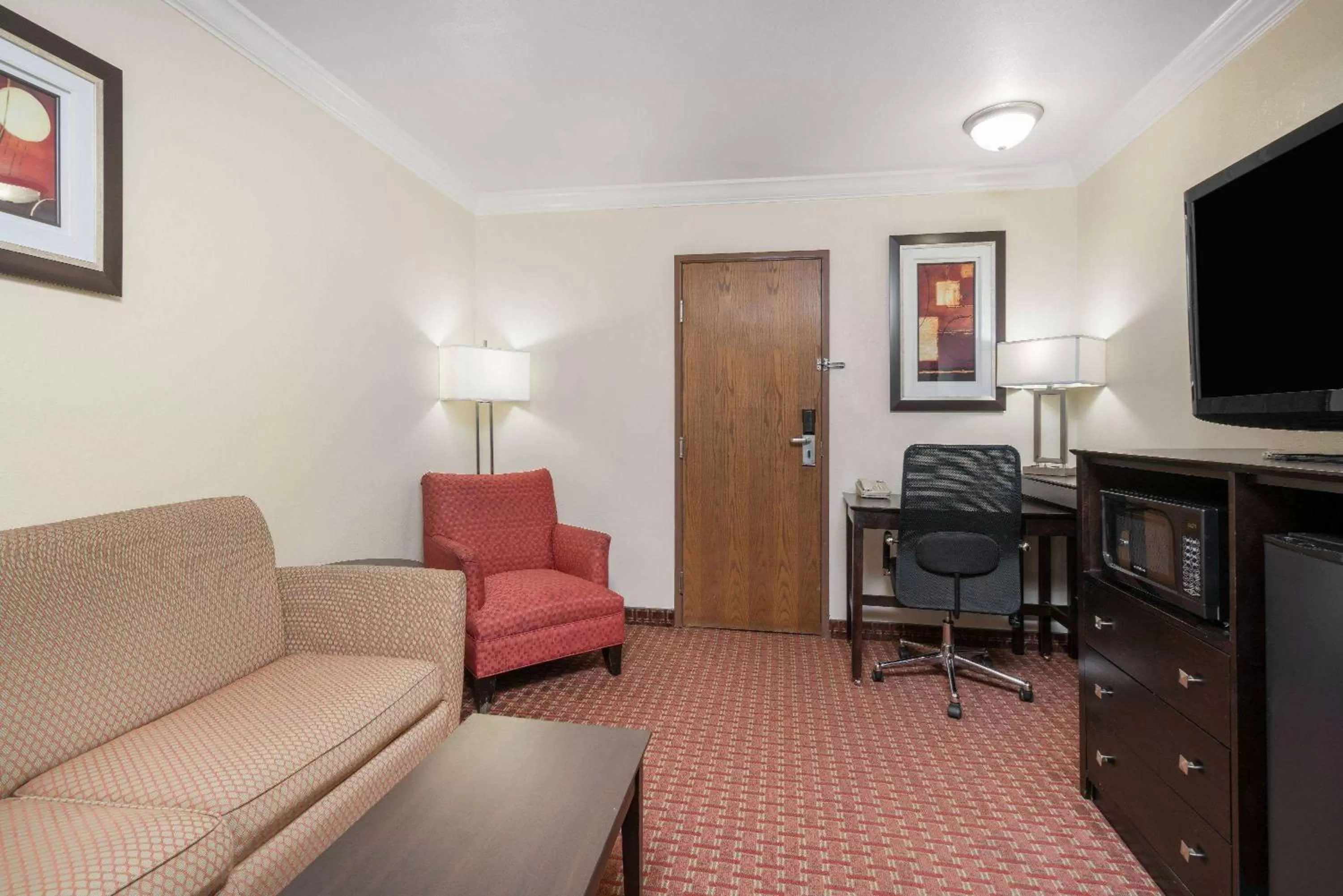 Living room in AmericInn by Wyndham Johnston Des Moines