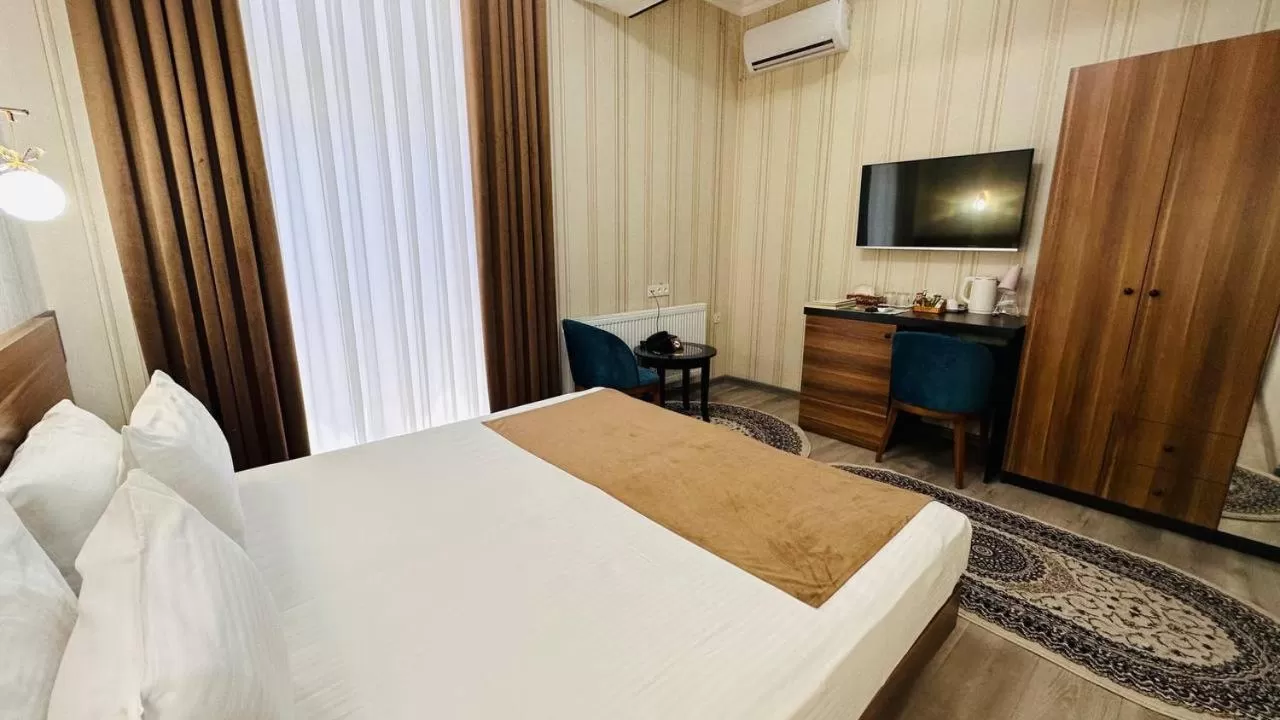 Communal lounge/ TV room, Bed in Garden Plaza Bukhara