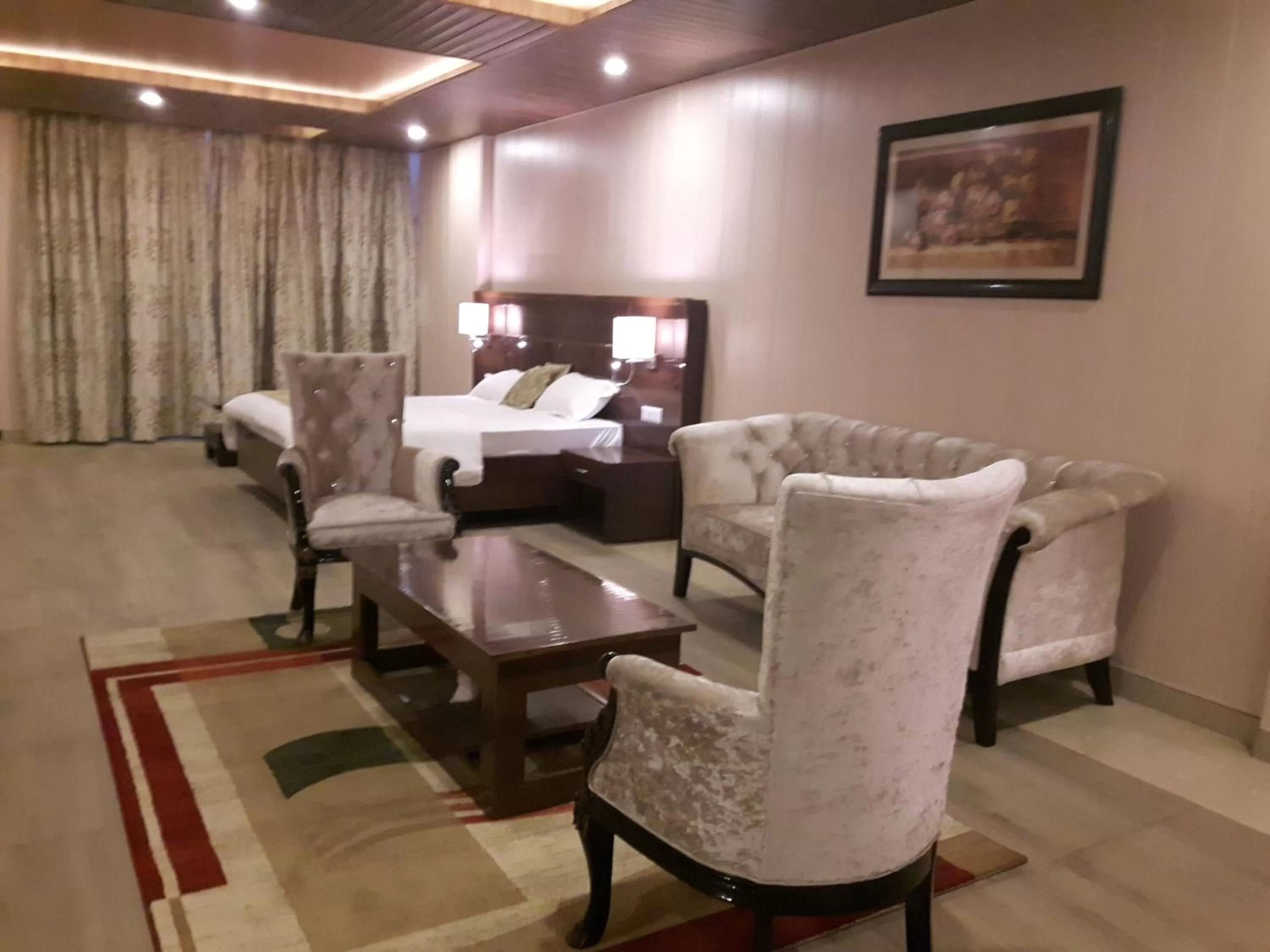 Seating area, Bed in Maple Leaf Hotel