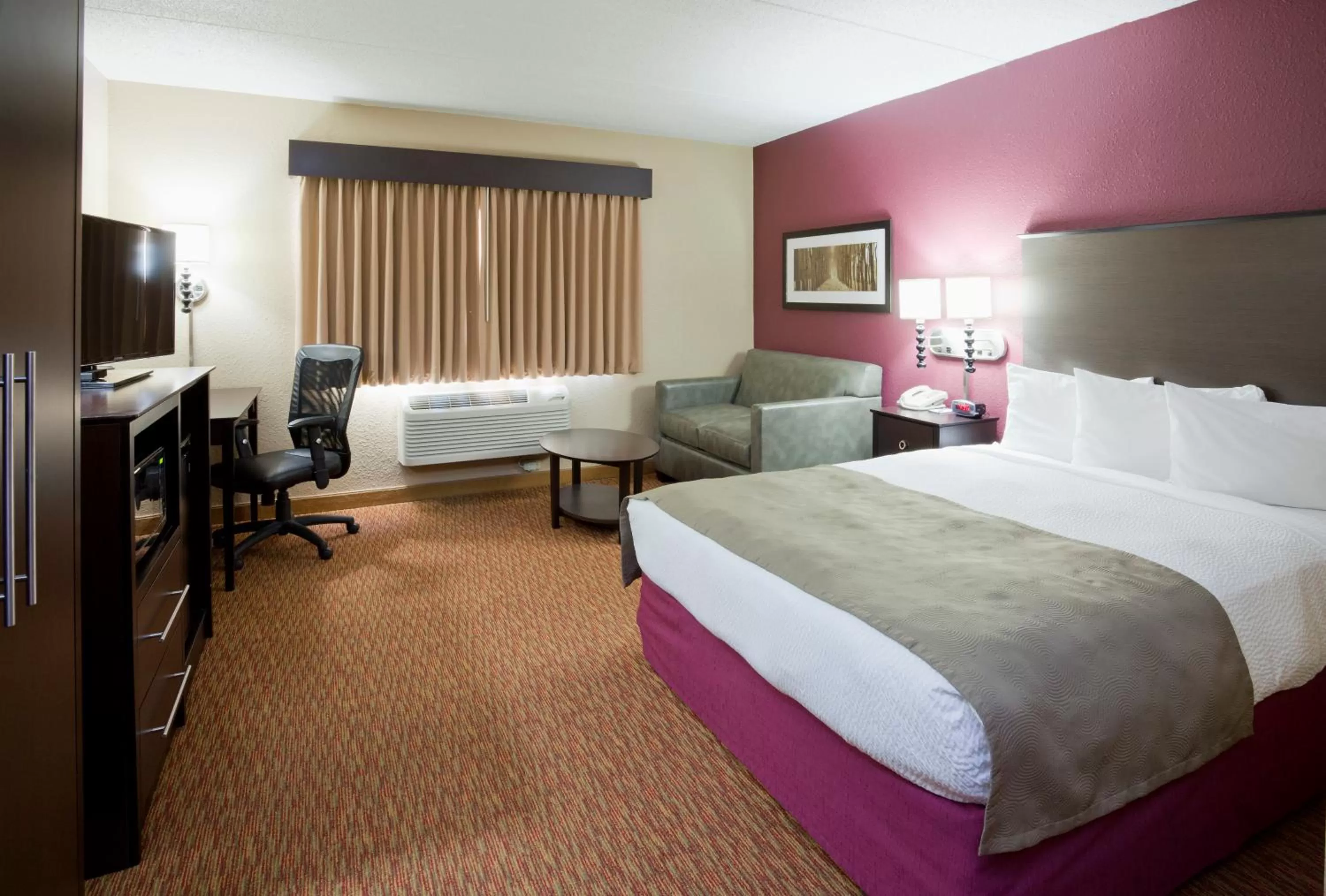 Bed in AmericInn by Wyndham Osceola