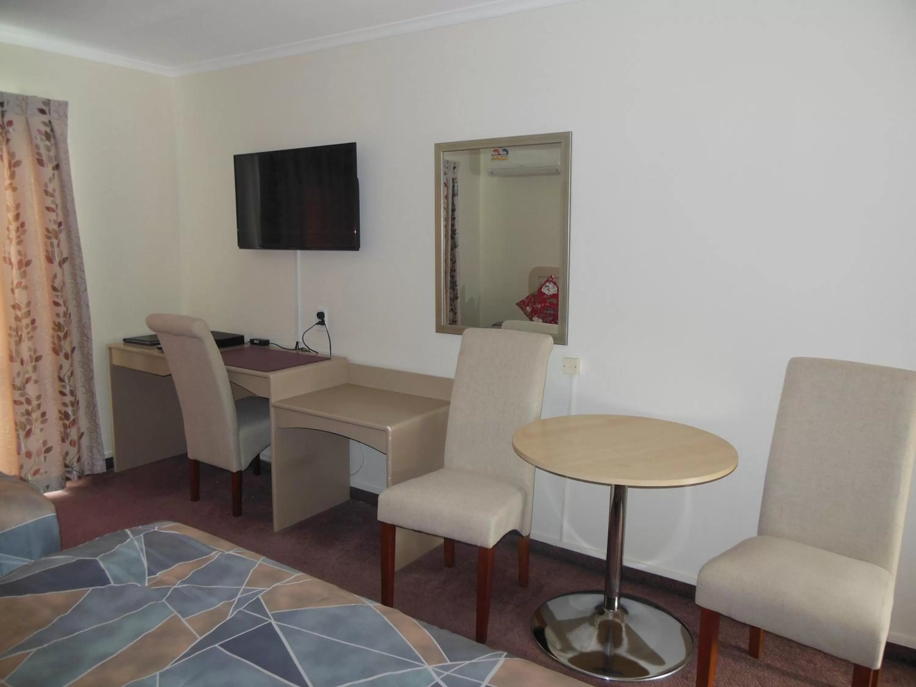 Living room in ASURE Camelot Arms Motor Lodge