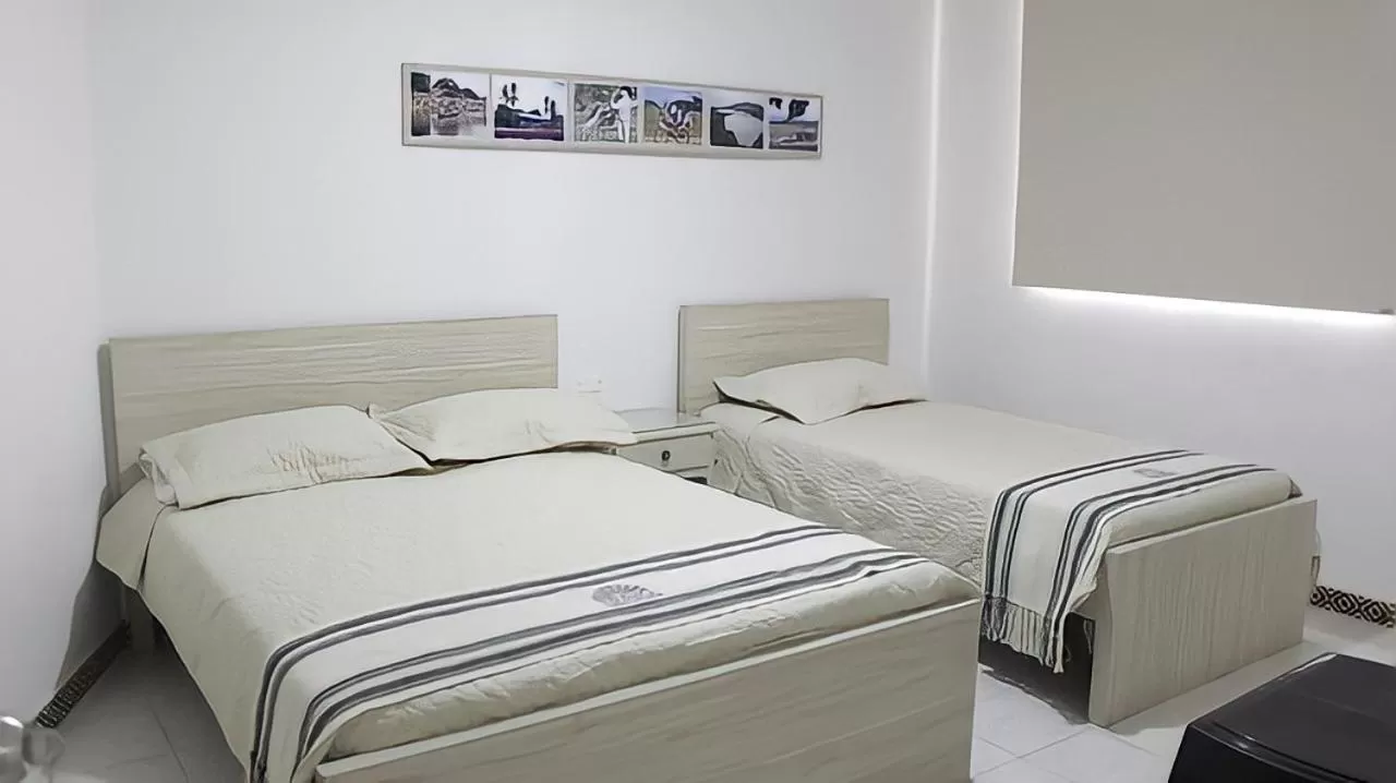 Bed in Hotel Iraka Zenu